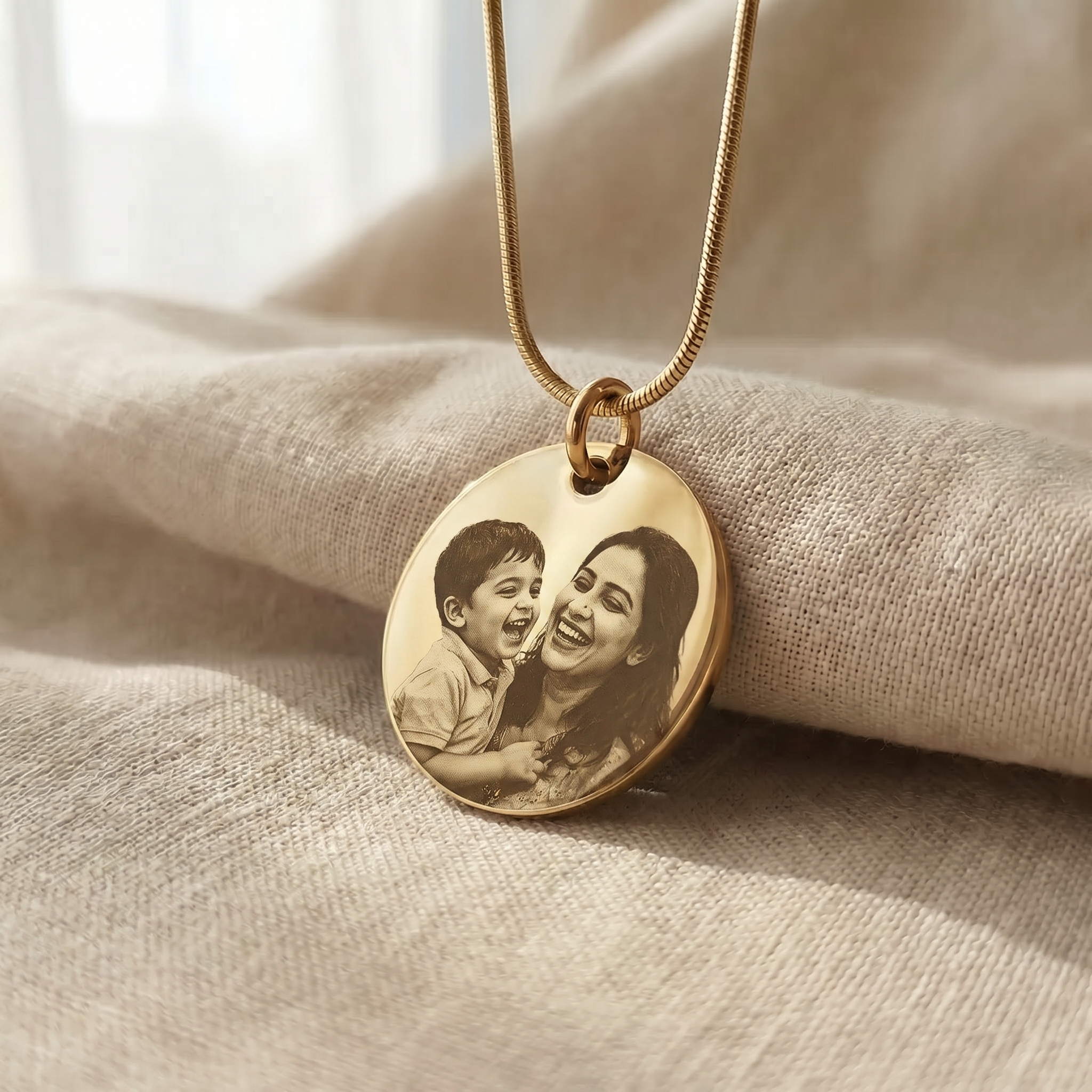 An open keepsake box with a pendant laid outside it on the table