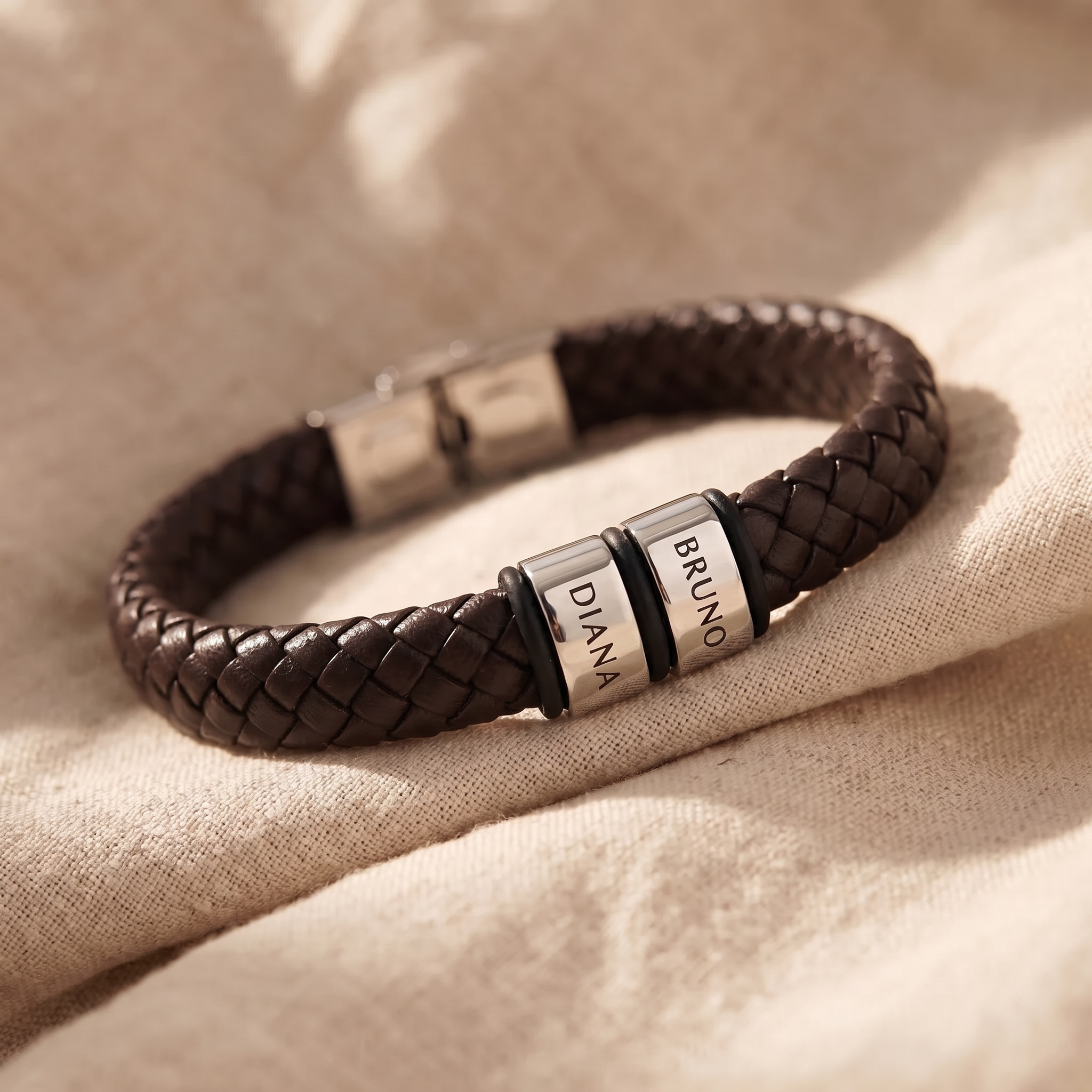 A leather bracelet and a crystal-set ring laid apart on a dry cloth