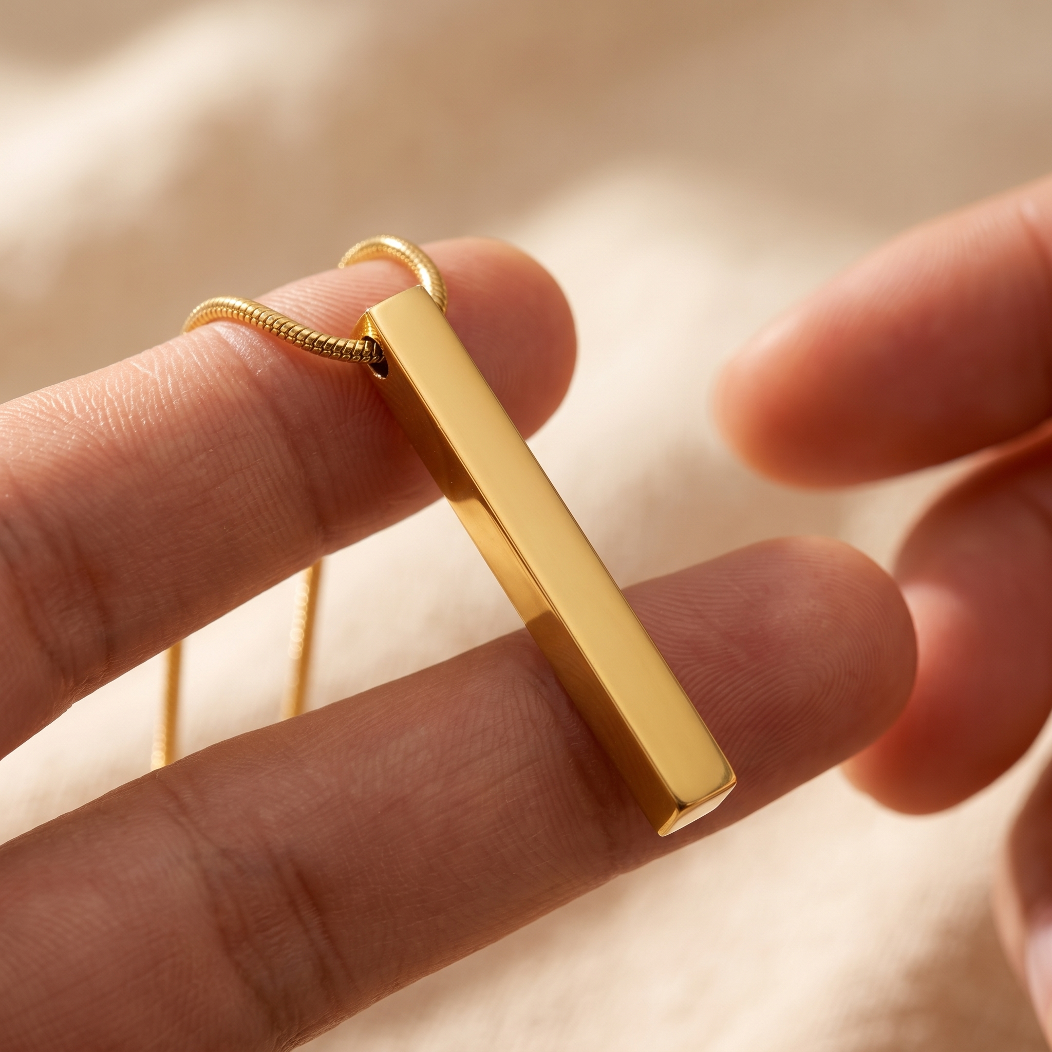 A plain disc pendant turned to show engraving on its reverse