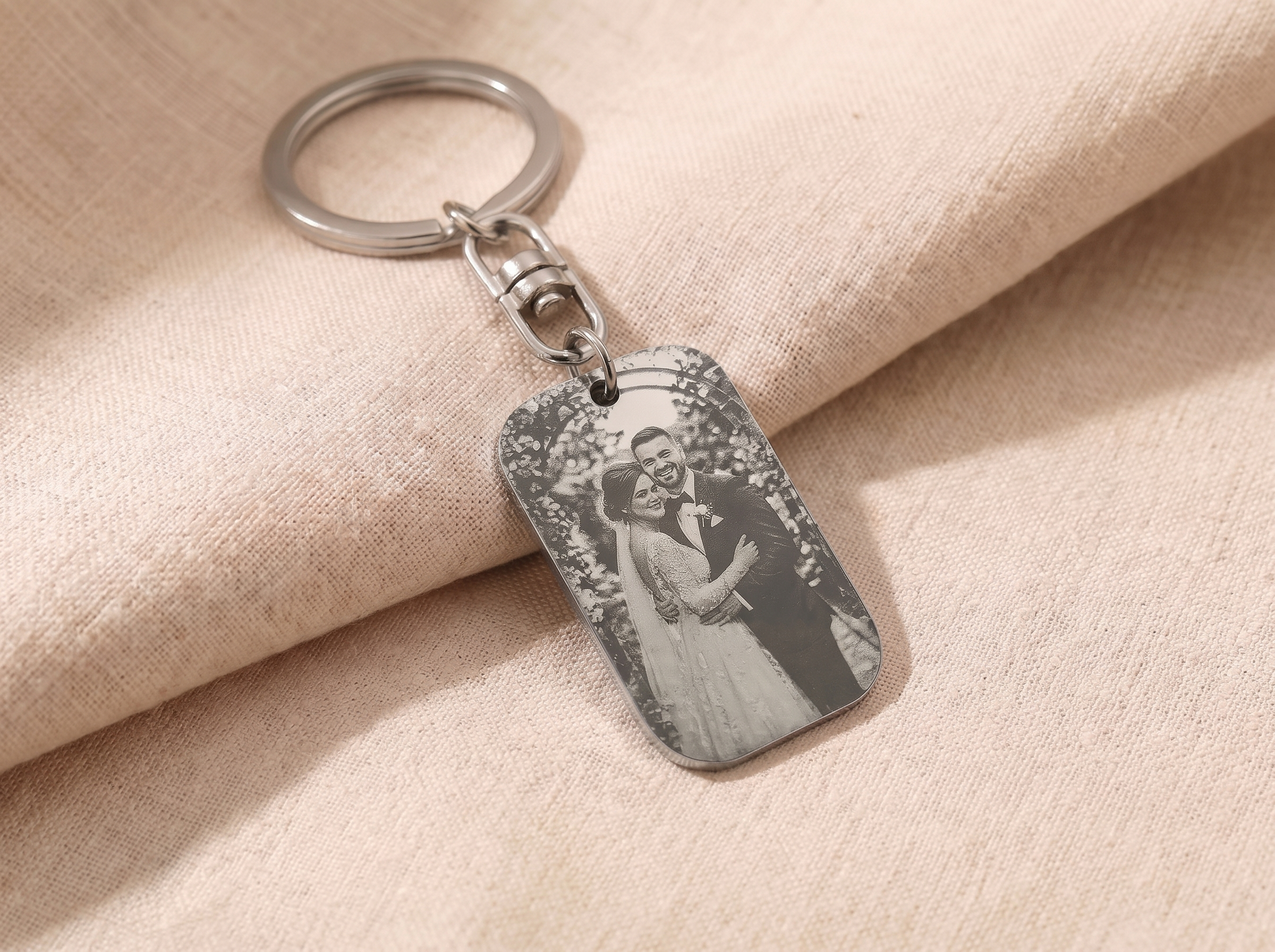 Car key with an engraved personalised tag keyring resting on a steering wheel
