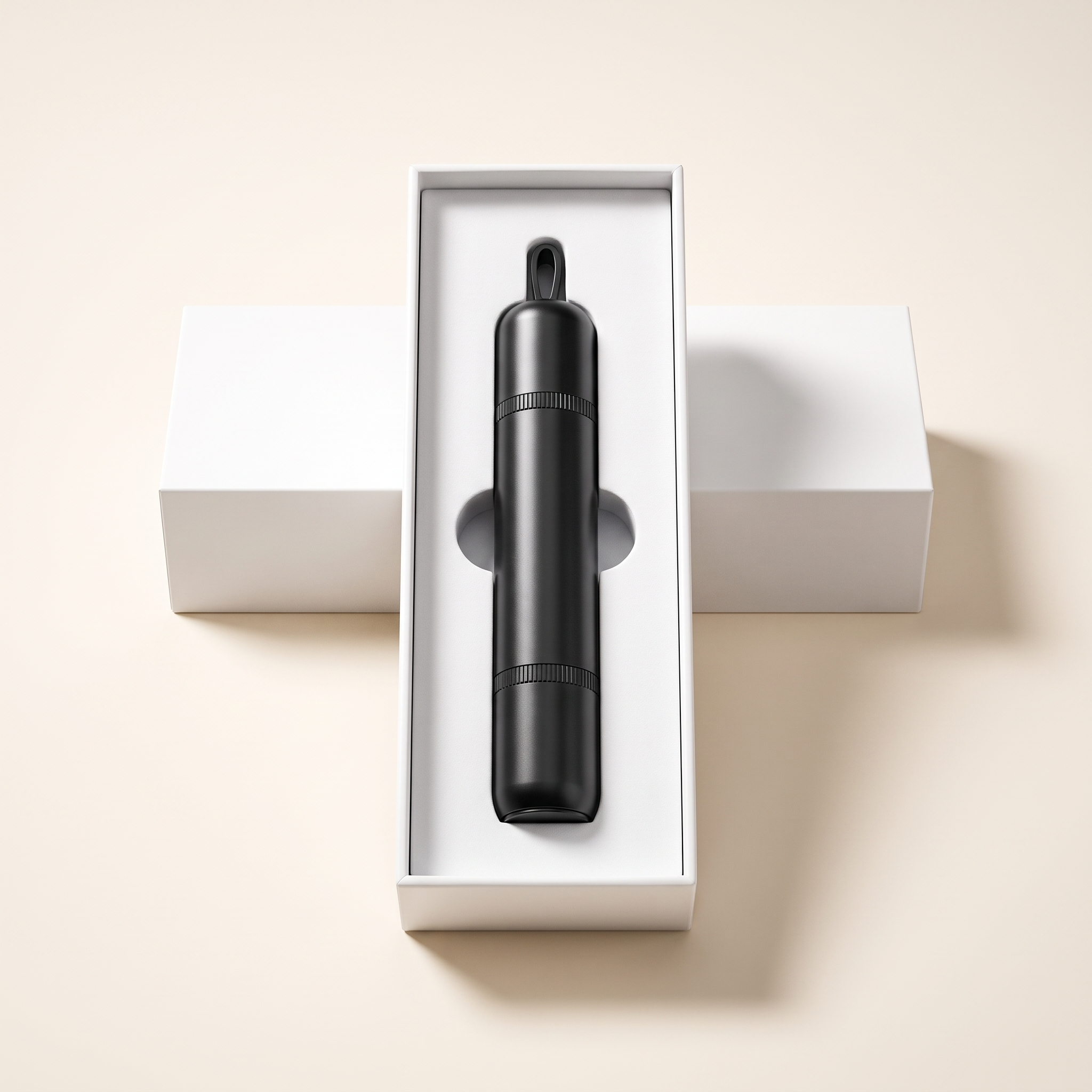 The full black cylindrical ExitReach car escape tool inside its fitted white presentation box