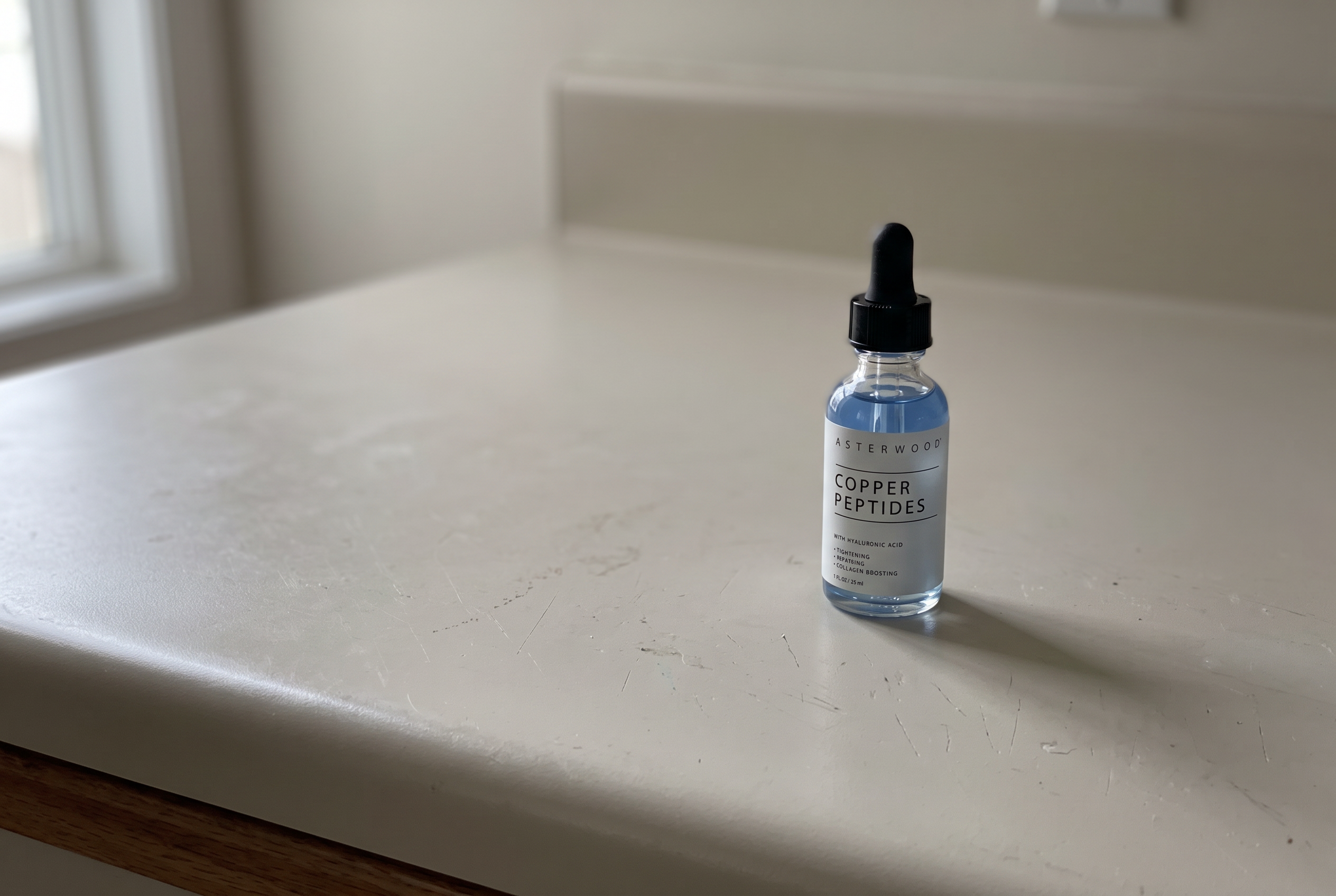 Asterwood Copper Peptides Serum bottle on a kitchen counter