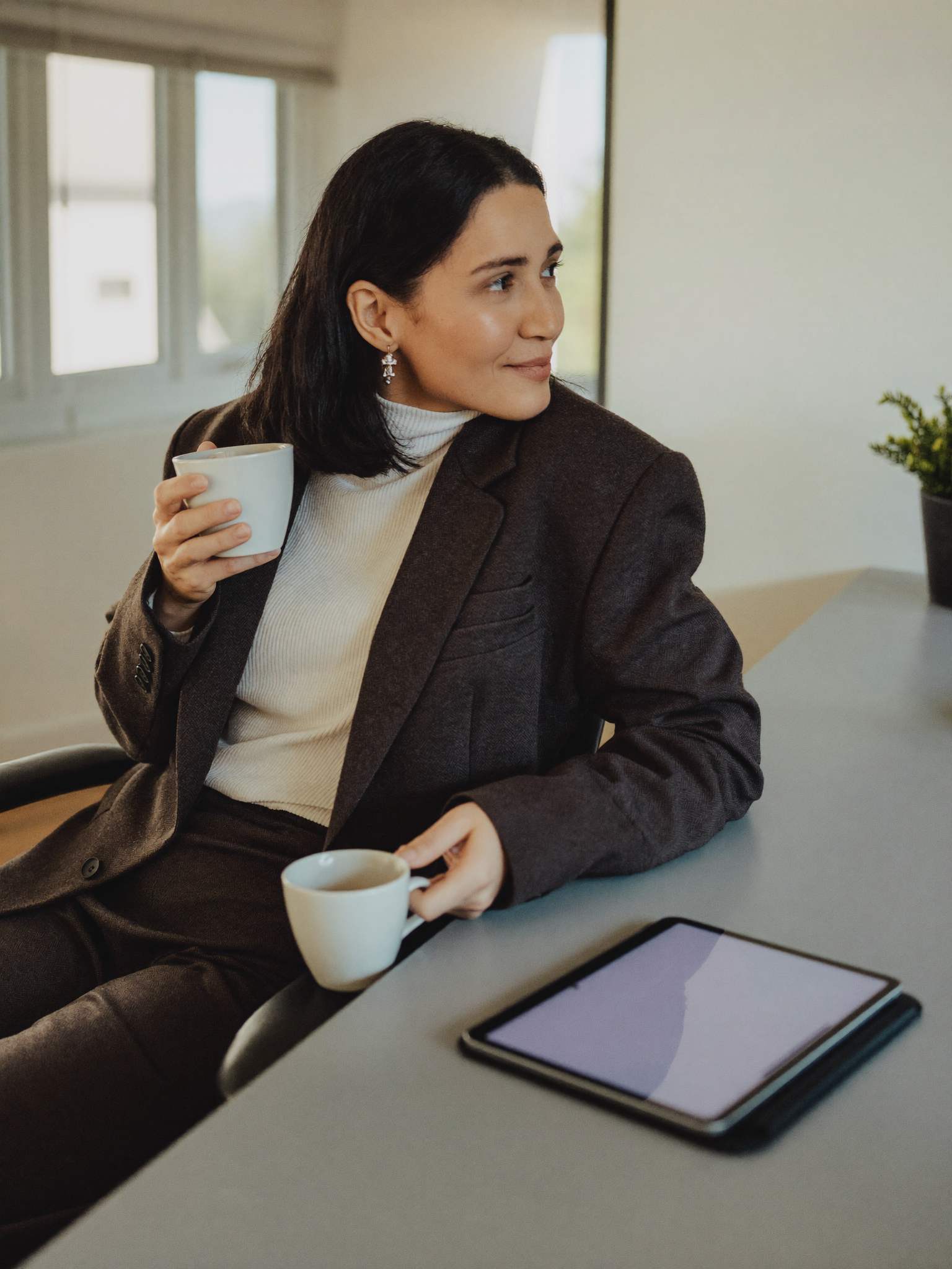 The same woman, resolved and confident, at her desk with a clear plan.