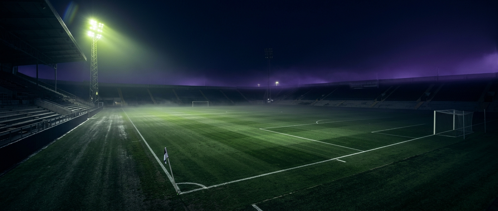 Empty floodlit soccer pitch at night