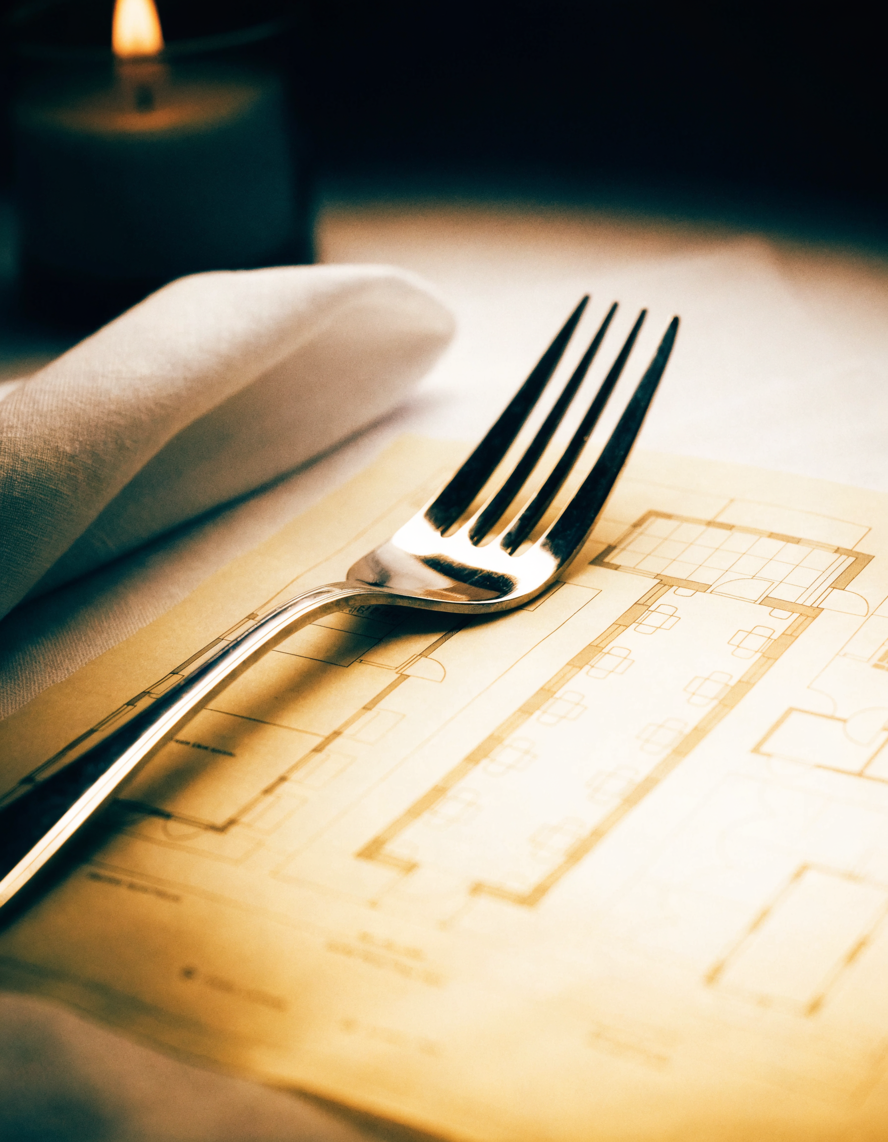 A blueprint resting on white table linen