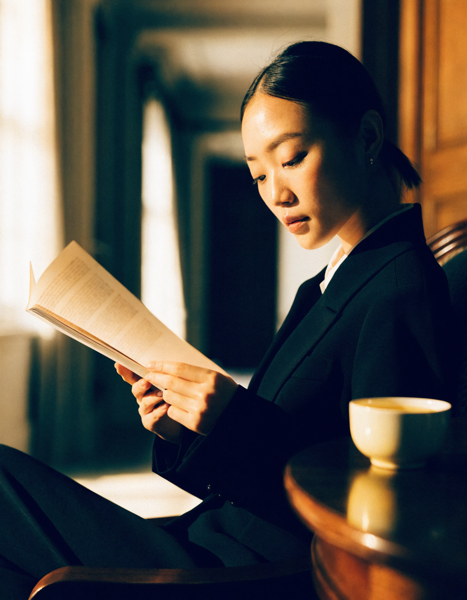 A calm woman reading a bound report