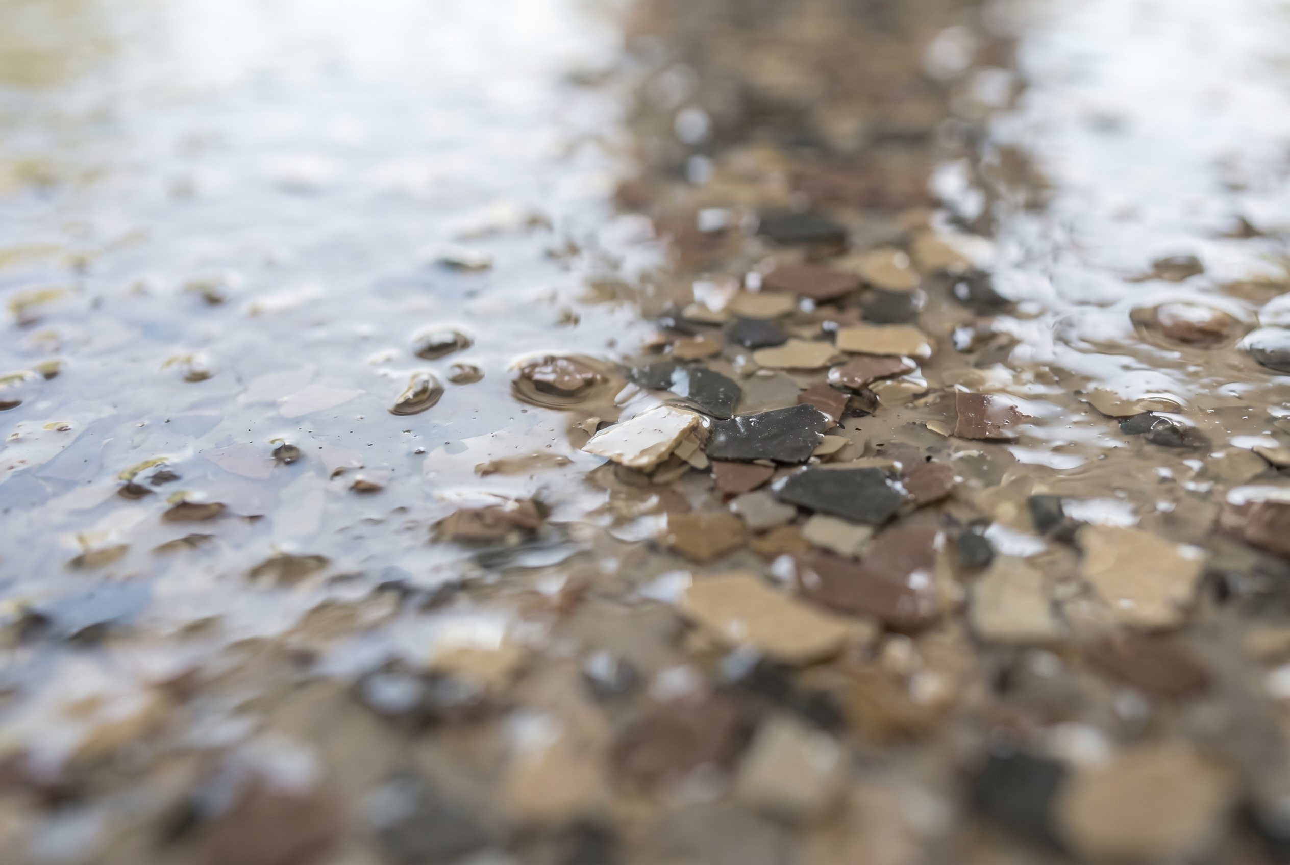 Close-up of decorative vinyl color flake chips in epoxy floor coating