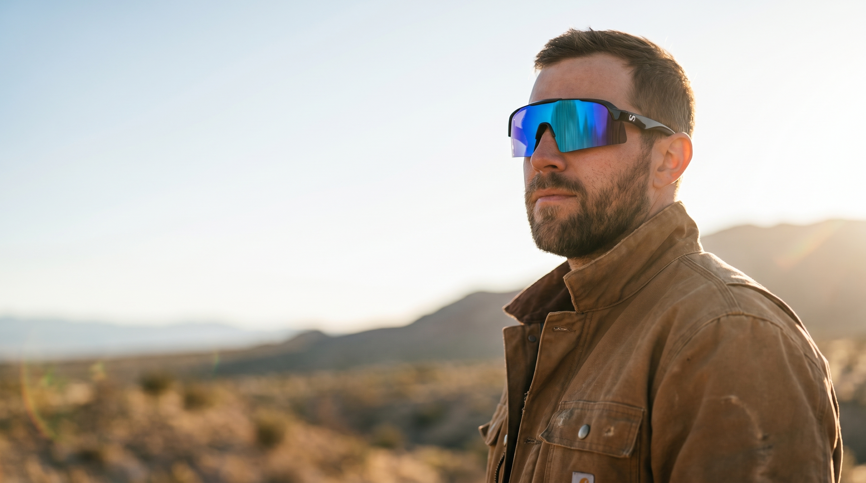Tradesman wearing Sunneys Rangers safety sunglasses in a golden-hour desert landscape