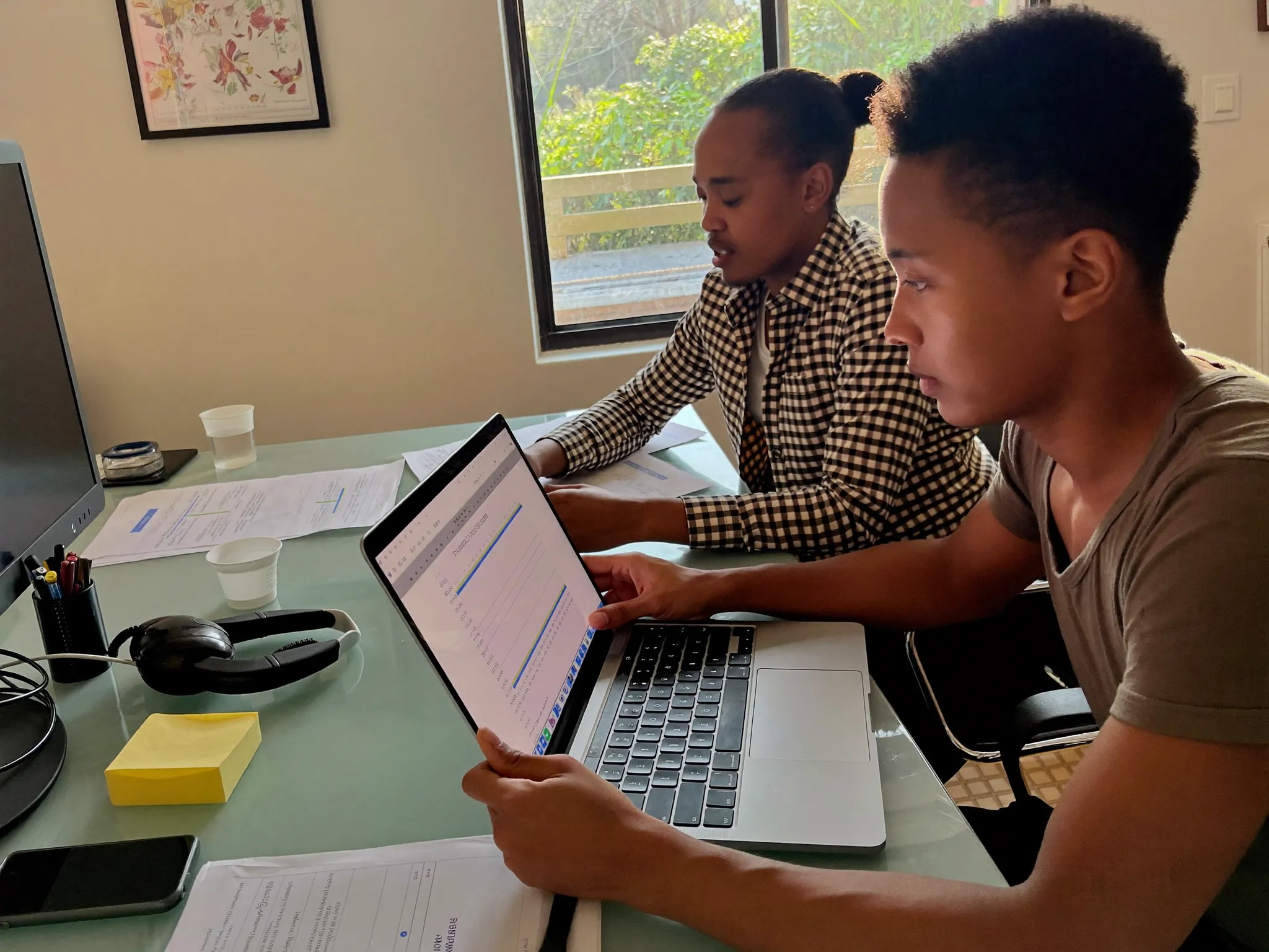 Two researchers reviewing survey data at an office desk