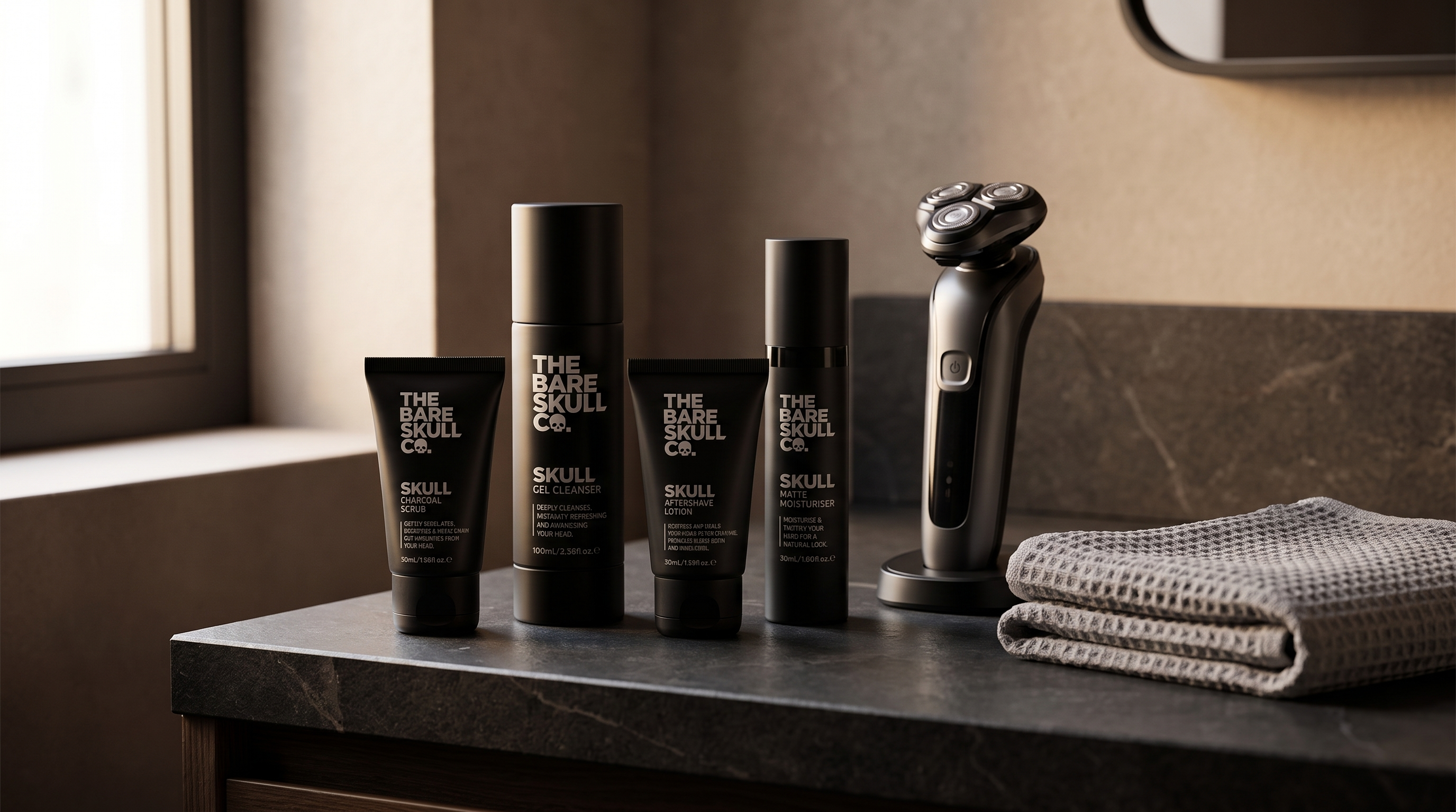 The Bare Skull Electric Shave Kit, Dry, next to an electric razor on a charcoal bathroom counter