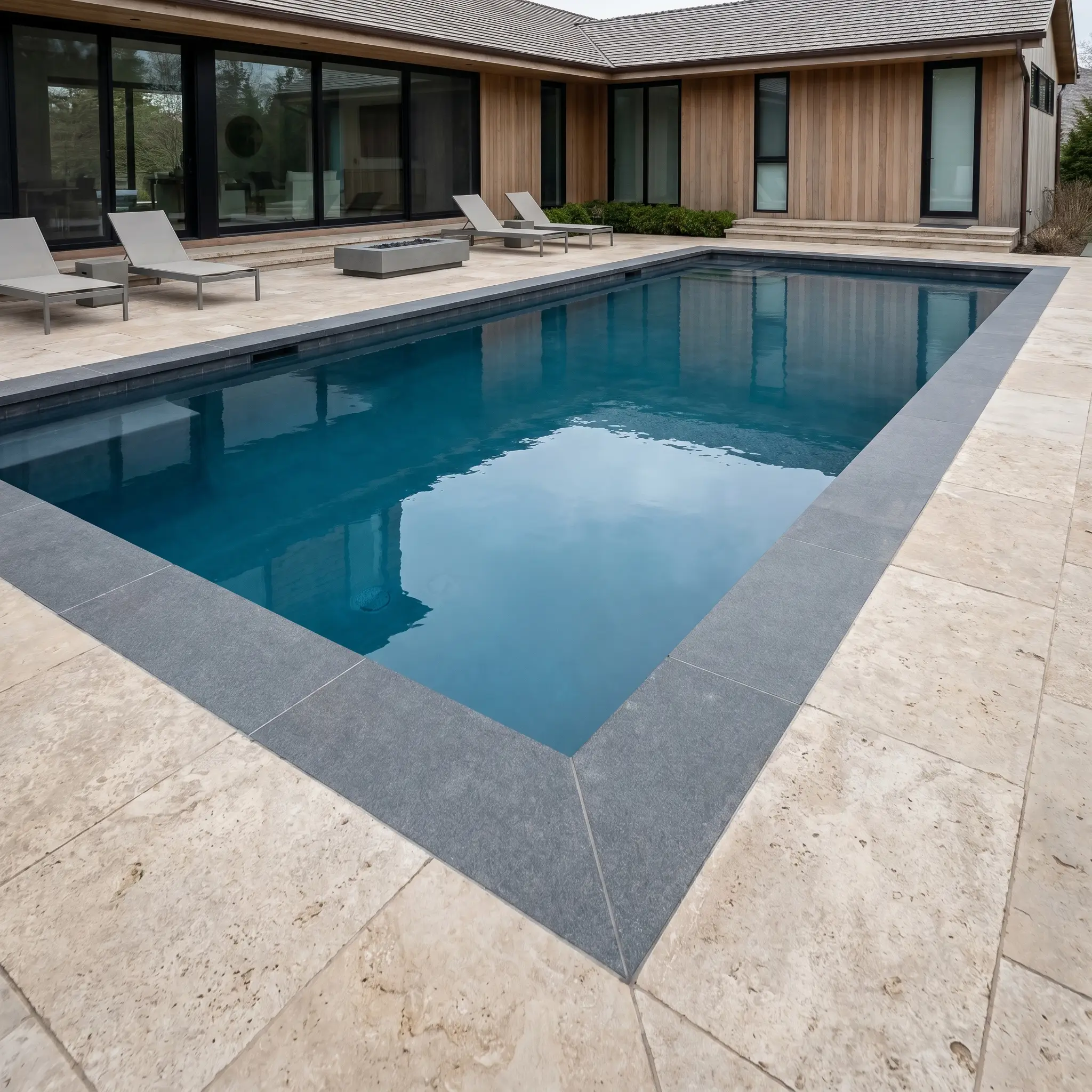Modern rectangular pool with stone hardscape