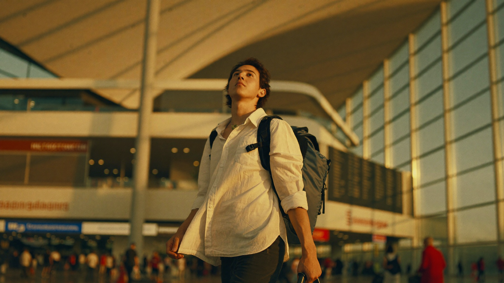 Solo traveller arriving at Bangkok's Suvarnabhumi airport, departure hall glowing with golden light