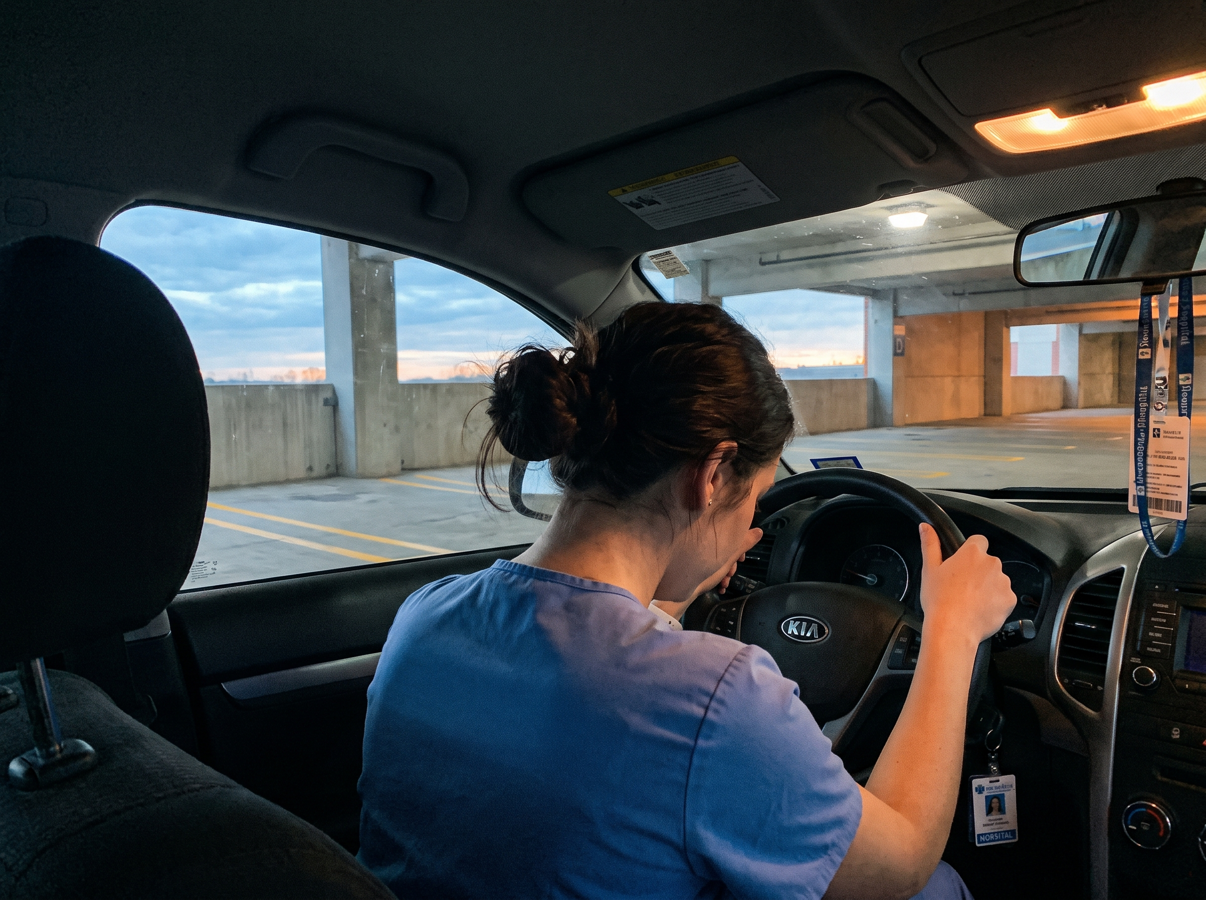 New nurse sitting in her car in a hospital parking garage before shift