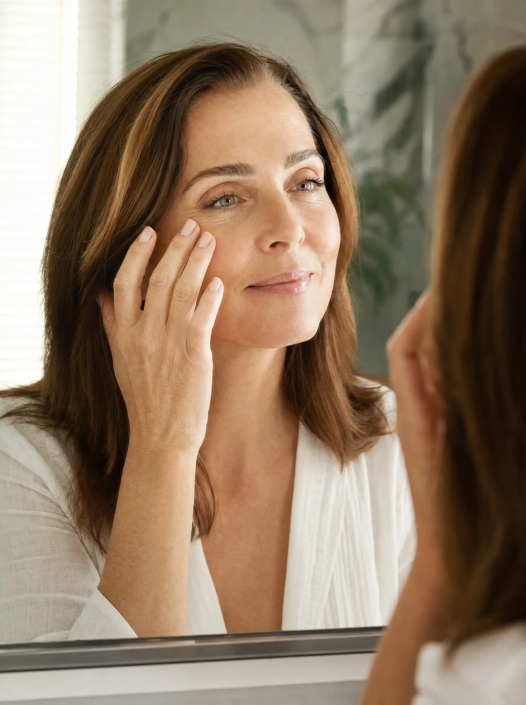 Woman smiling at her rested reflection