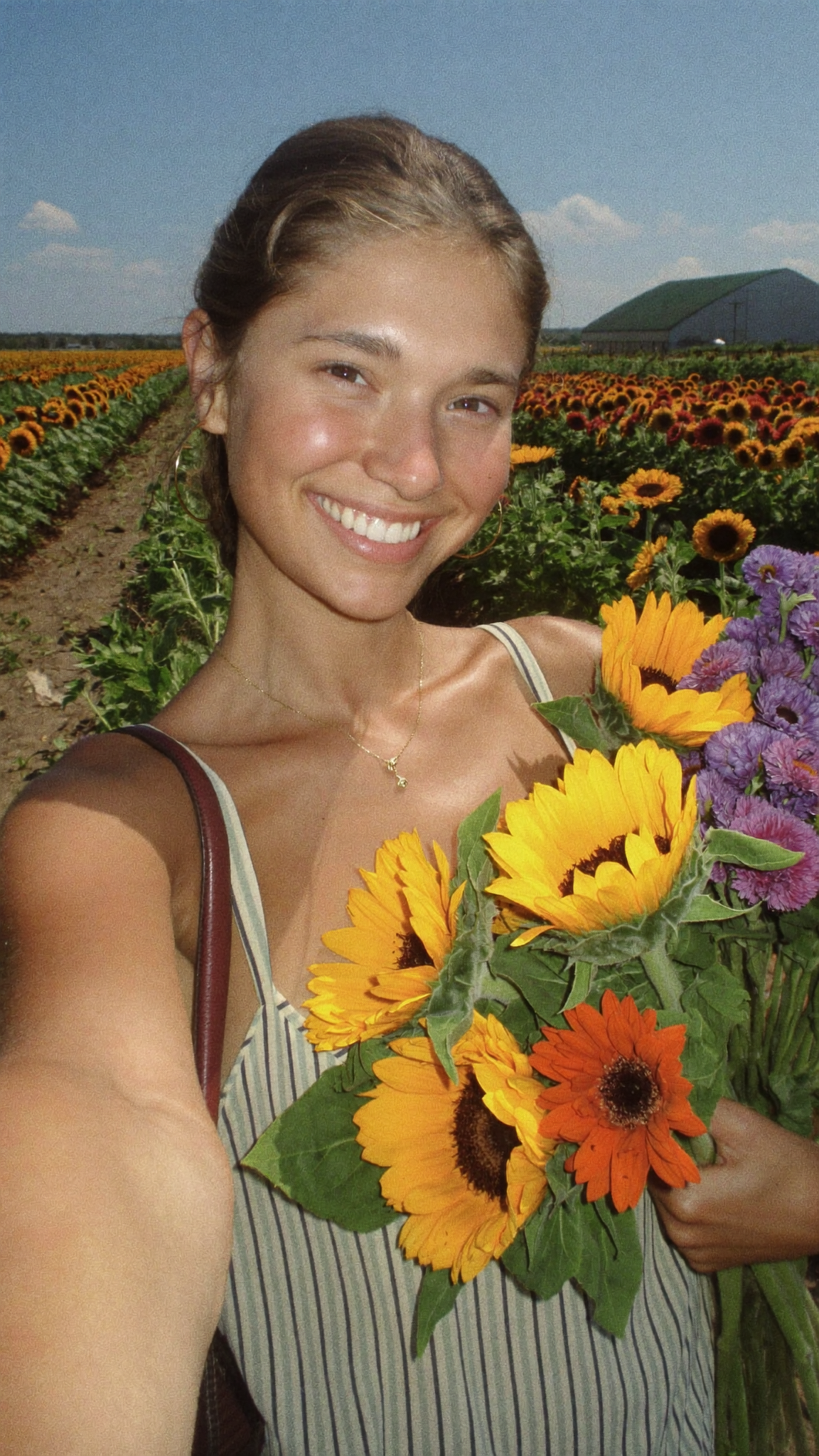 A creator filming herself at a U-pick flower field