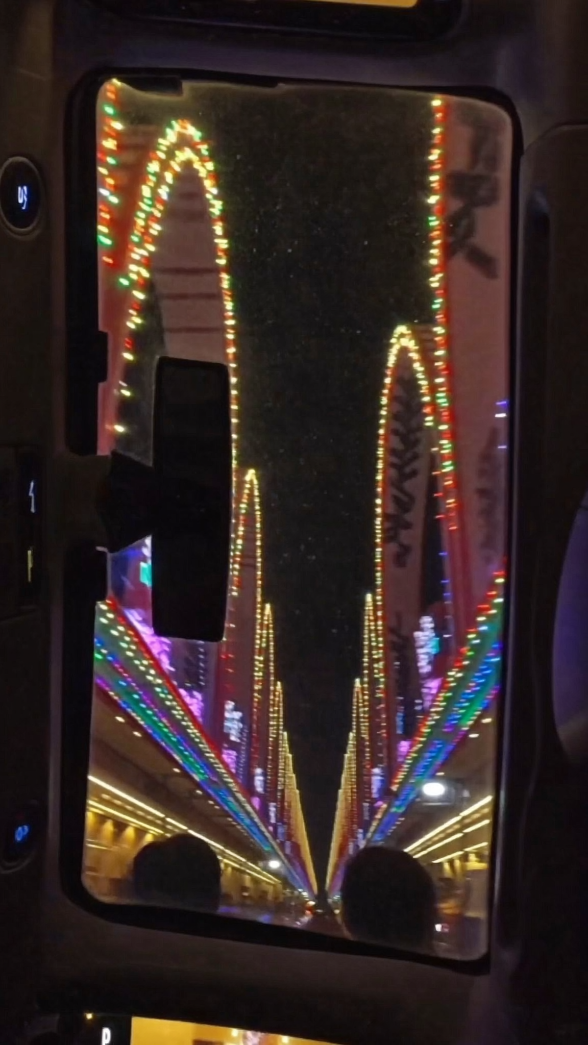 Filming a Christmas lights drive-through from the car
