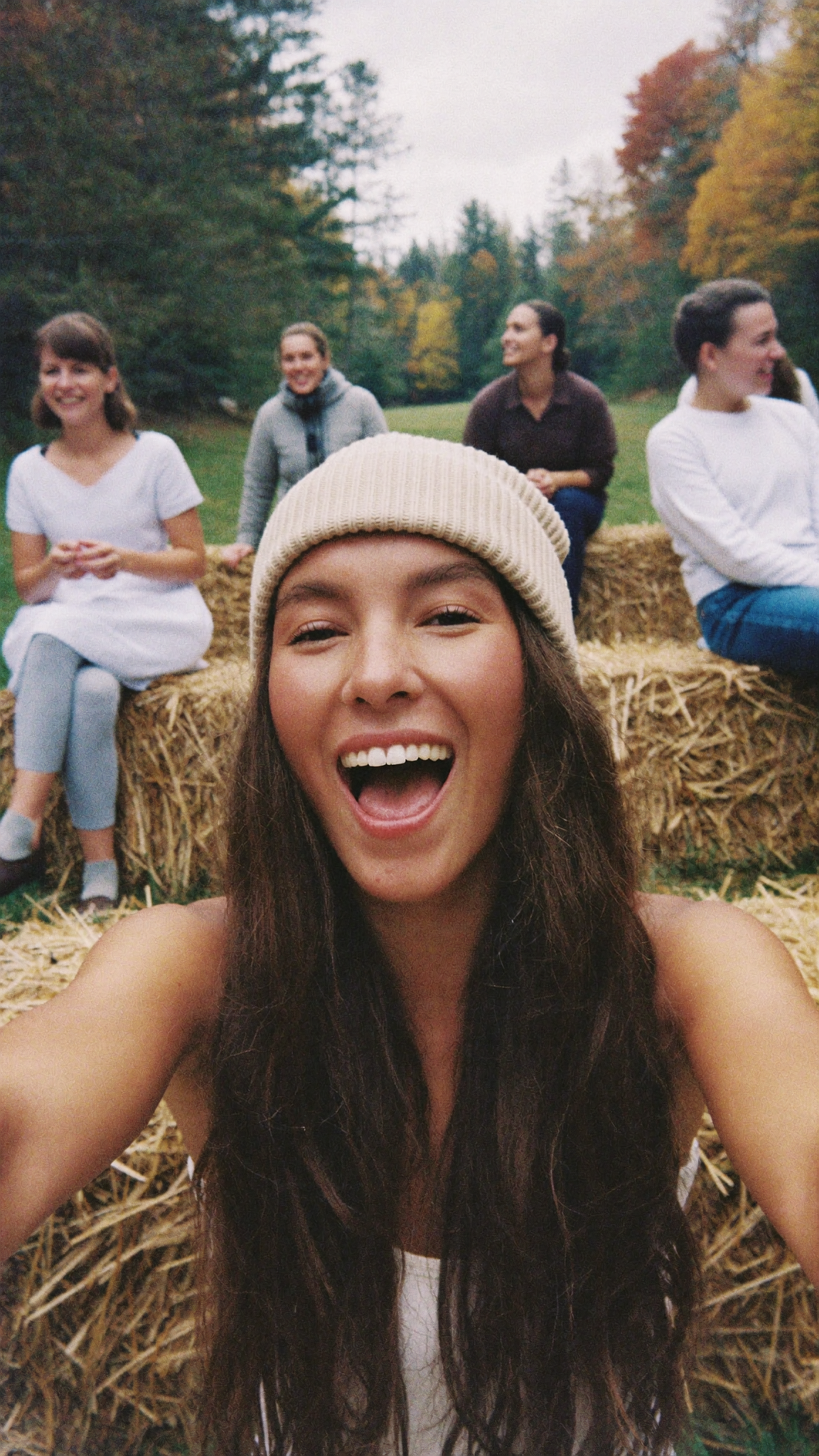 A woman filming herself on a hayride