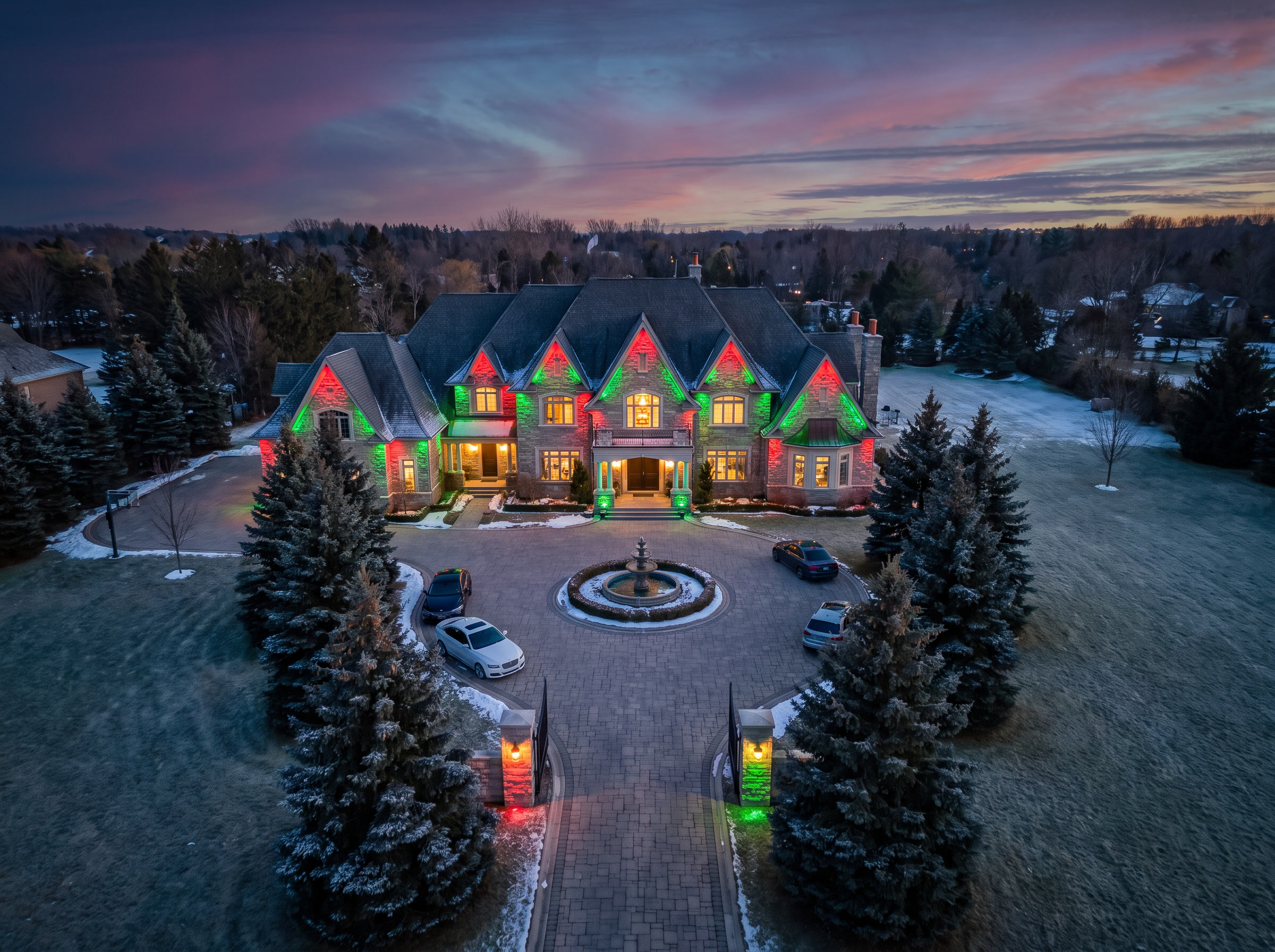 Drone view of a King City estate manor with holiday permanent lighting