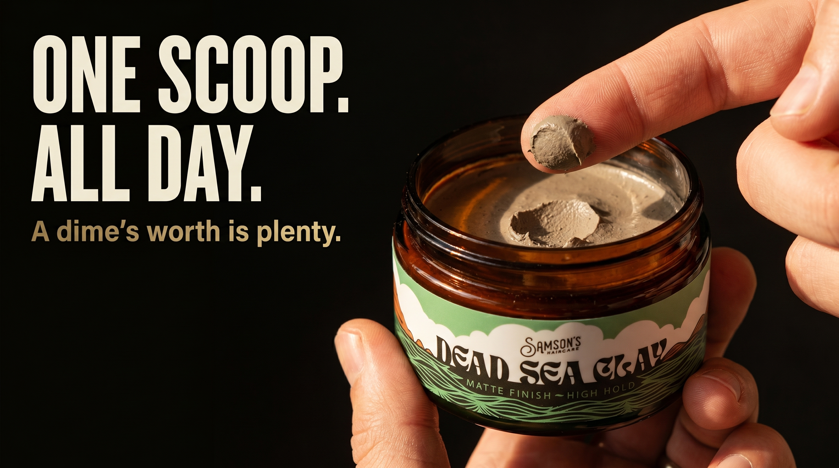 A dime-sized scoop of Samson's Dead Sea Clay on a fingertip over the open amber glass jar