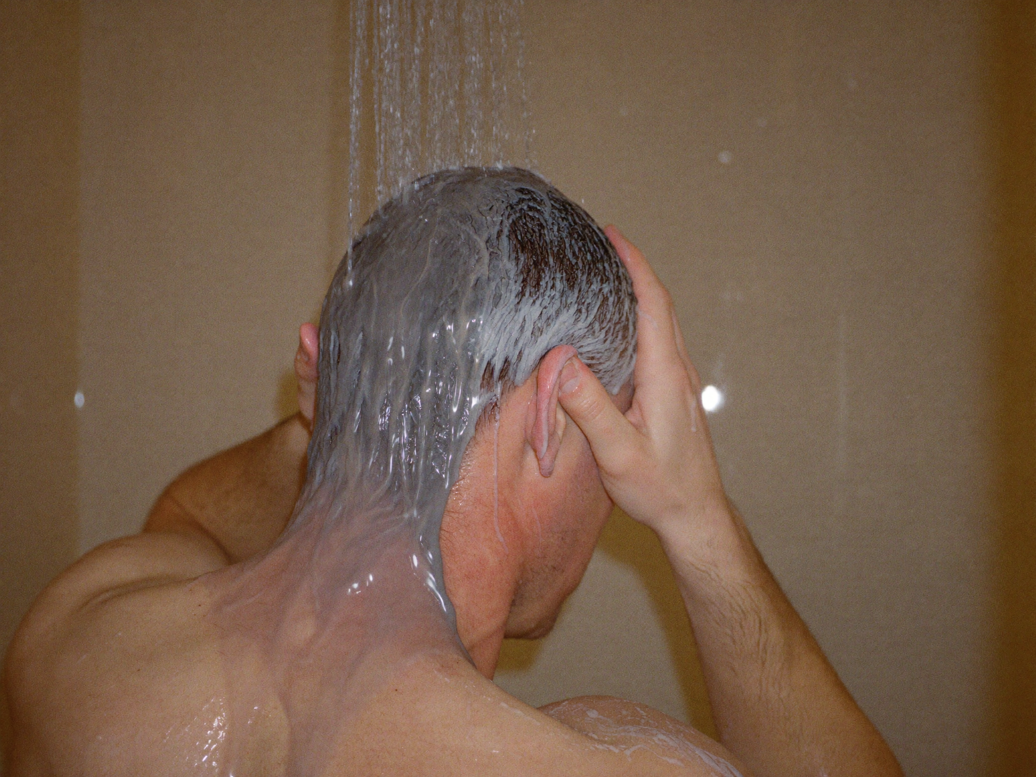 Rinsing hair clay out clean with water in the shower