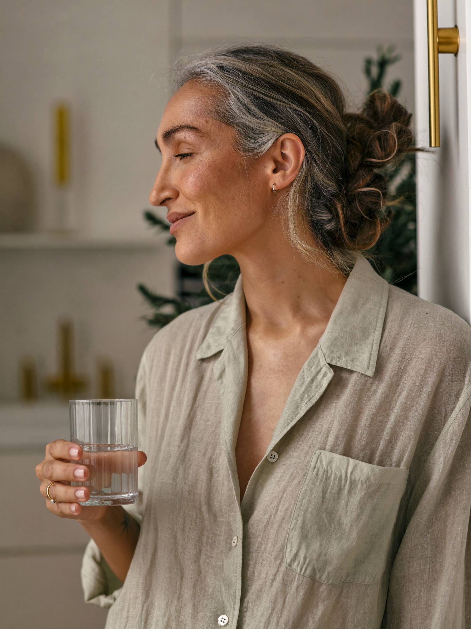 A woman in a bright kitchen in morning light