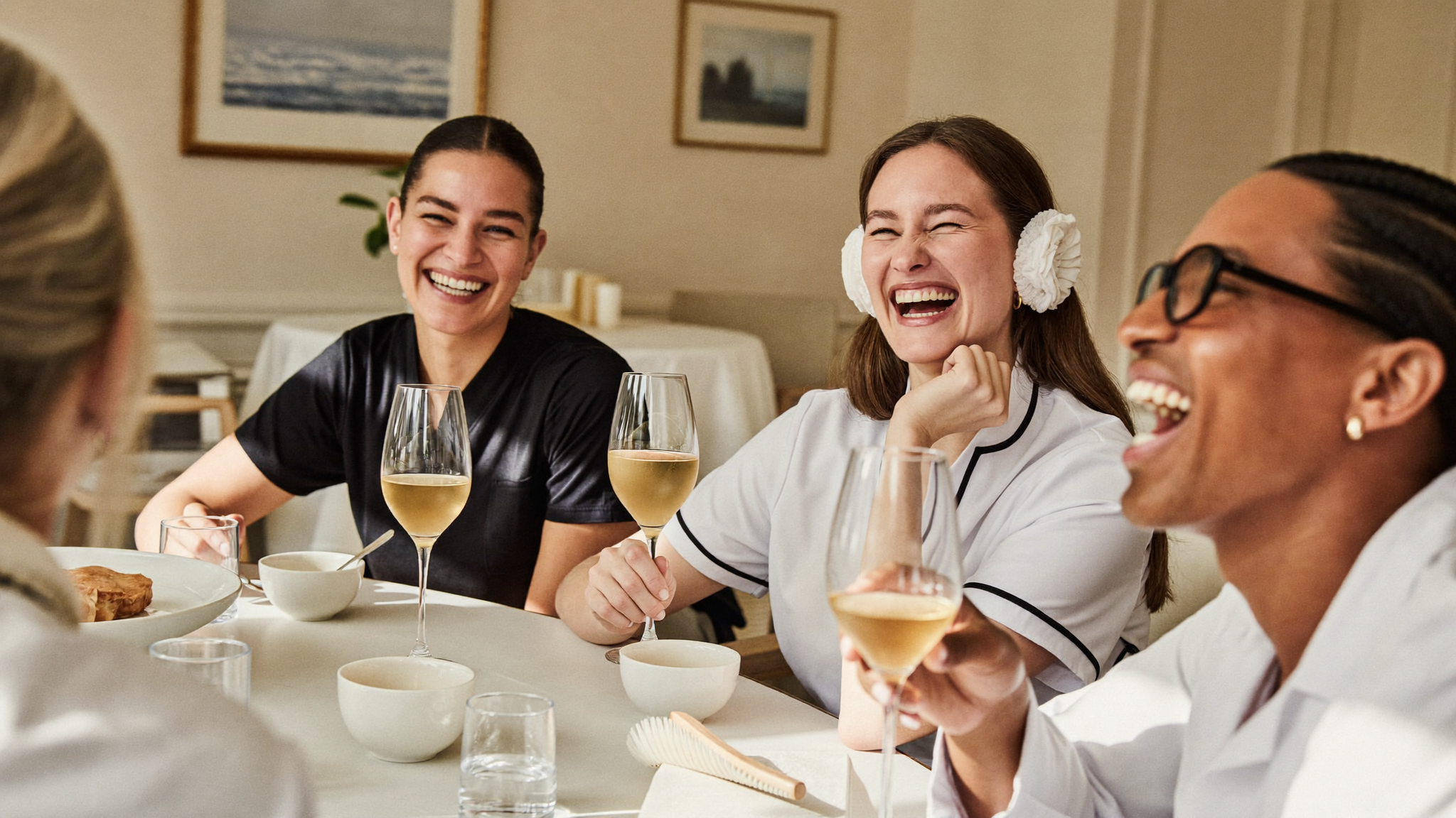 A smiling aesthetic practice staff team gathered in a bright break room