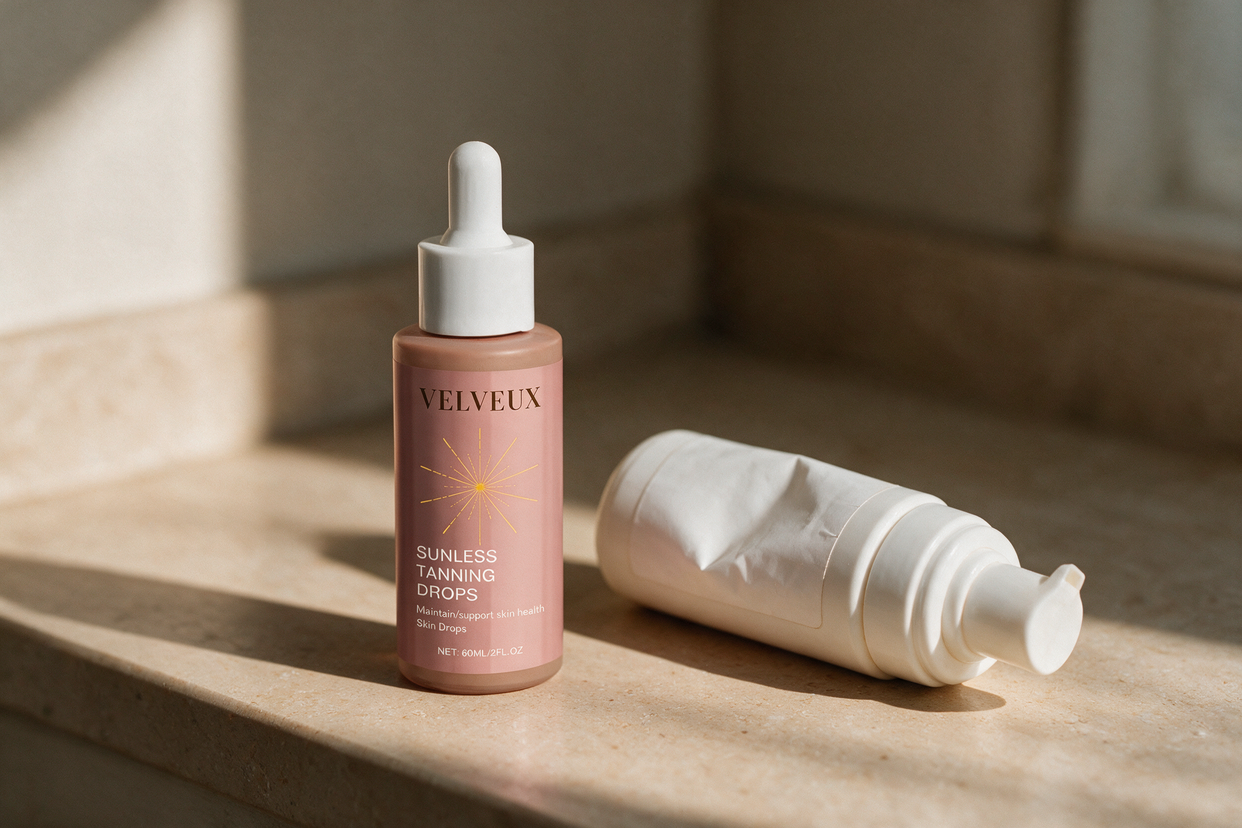 Velveux tanning drops op een badkamerplank naast een opgebruikte fles zelfbruinende mousse