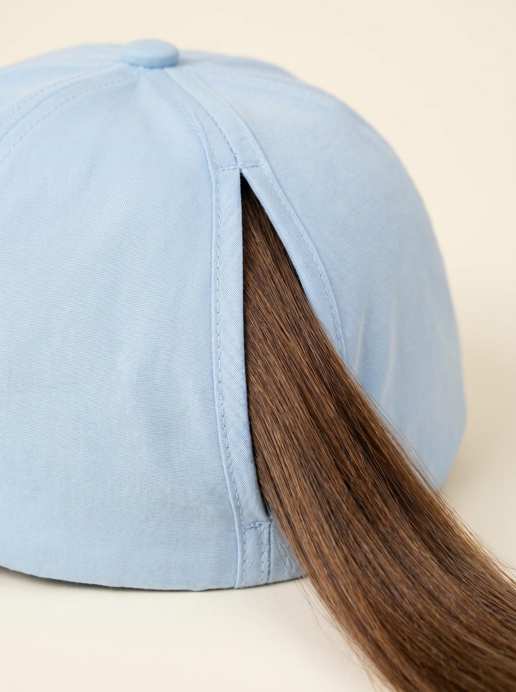Close-up of the magnetic open back splitting open for a ponytail