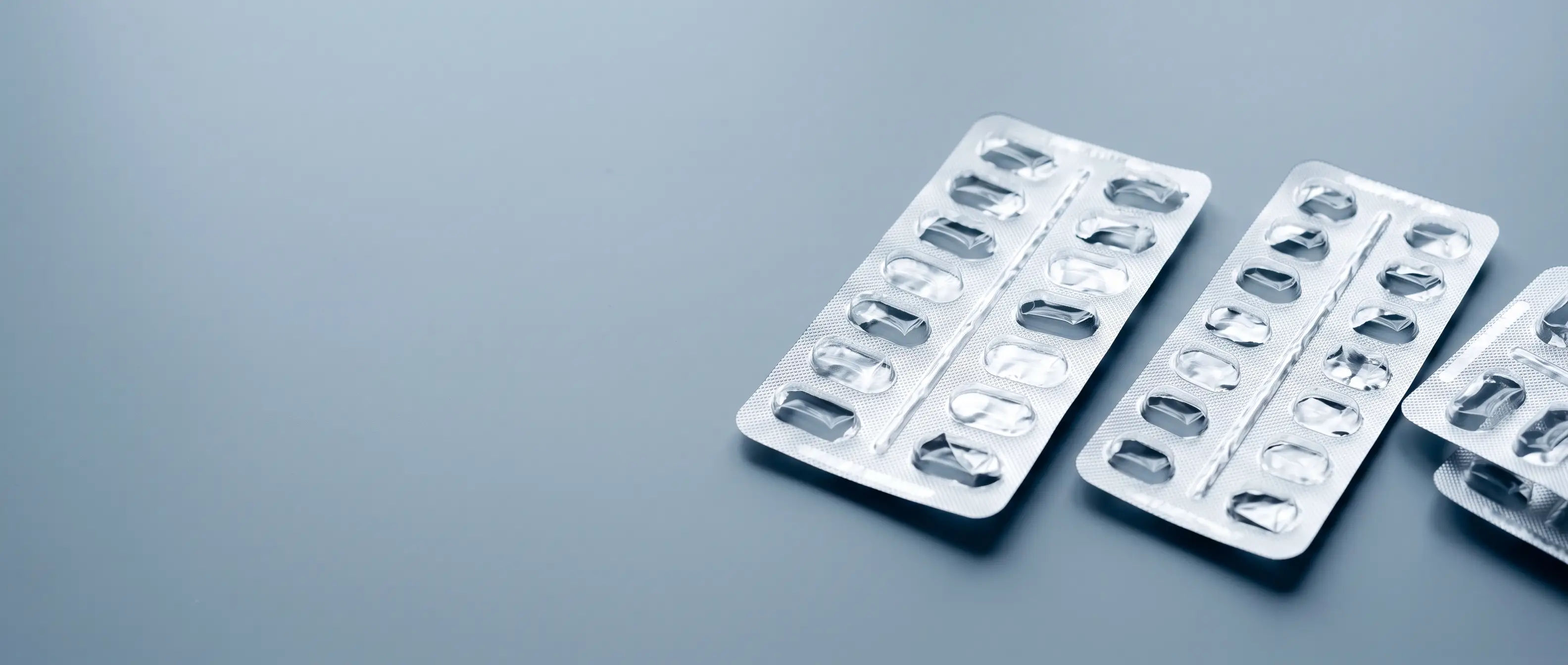 Push-through blister lidding foil — hard-temper printed aluminium lid on a filled tablet blister