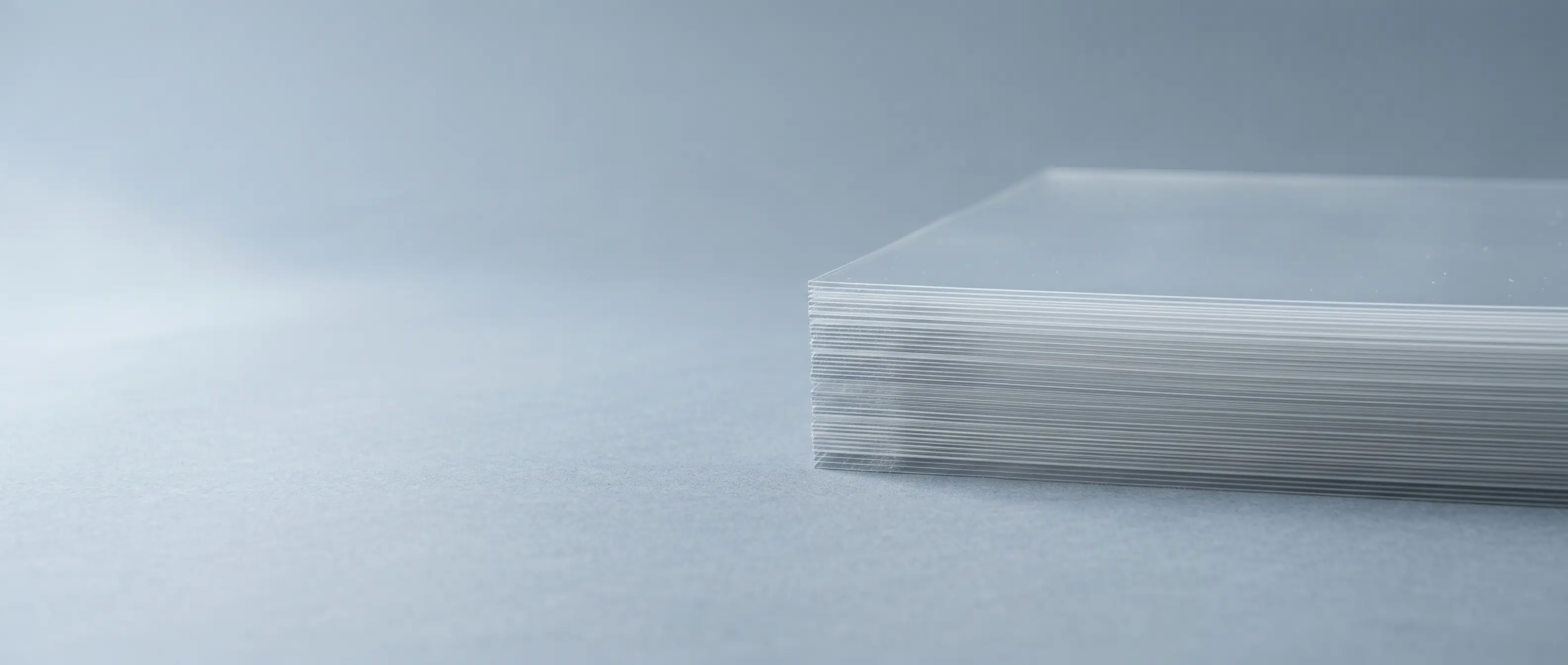 Cross-section of a coextruded barrier tray — a thin clear EVOH oxygen-barrier core buried between polypropylene skins with tie layers