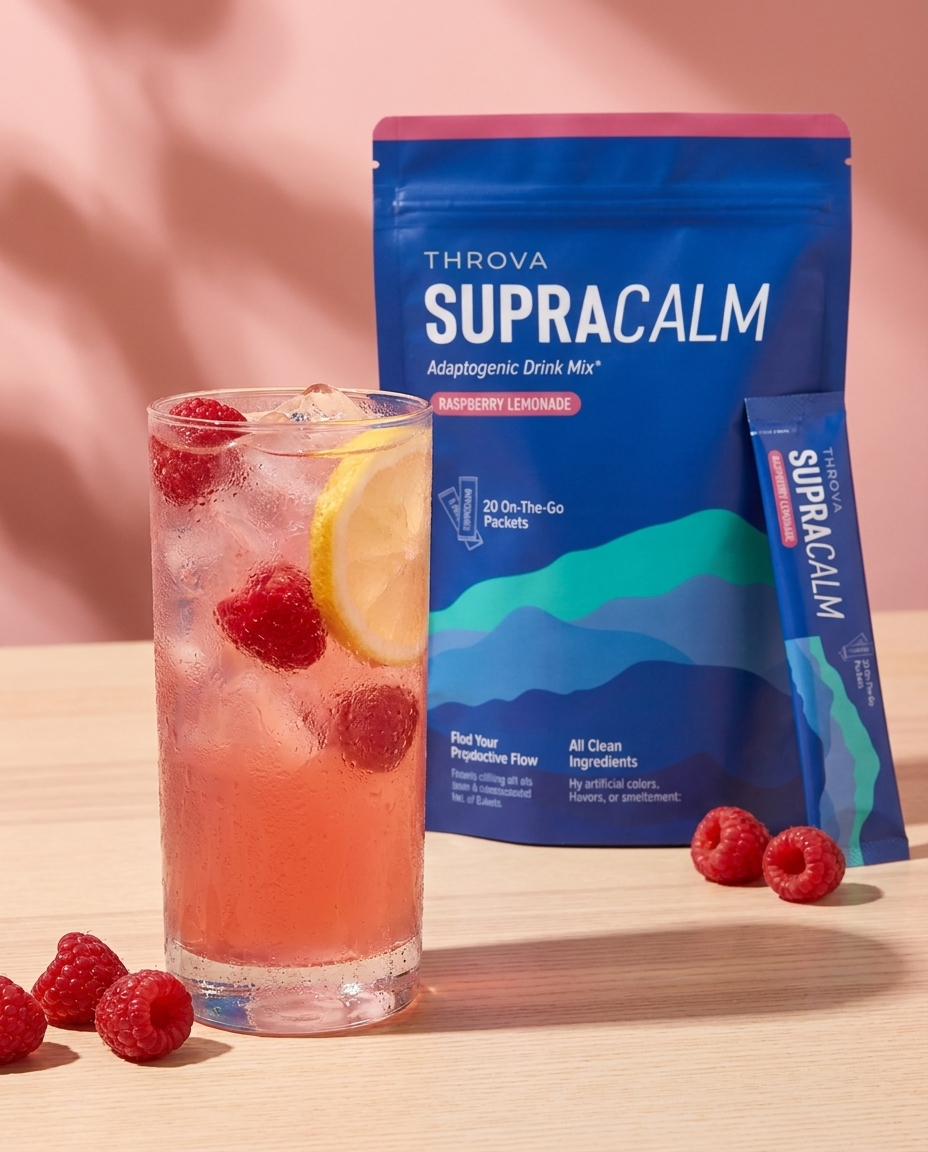 A cold glass of raspberry lemonade SupraCalm next to the pouch and a sachet