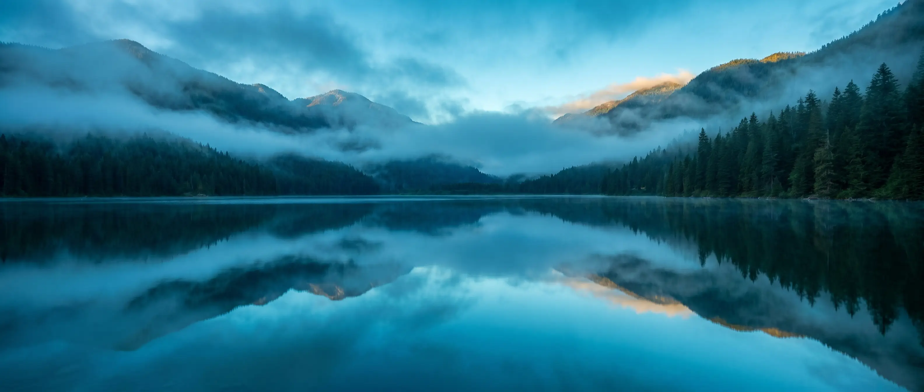 A still alpine lake at dawn