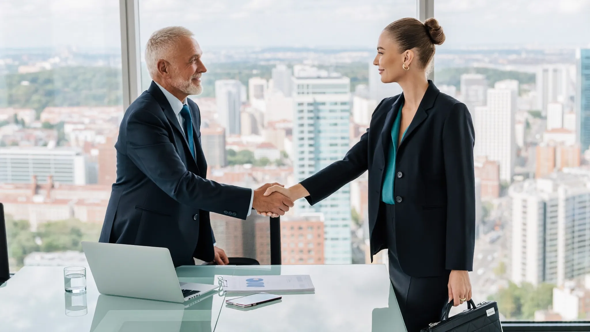Senior executives shaking hands in a bright boardroom
