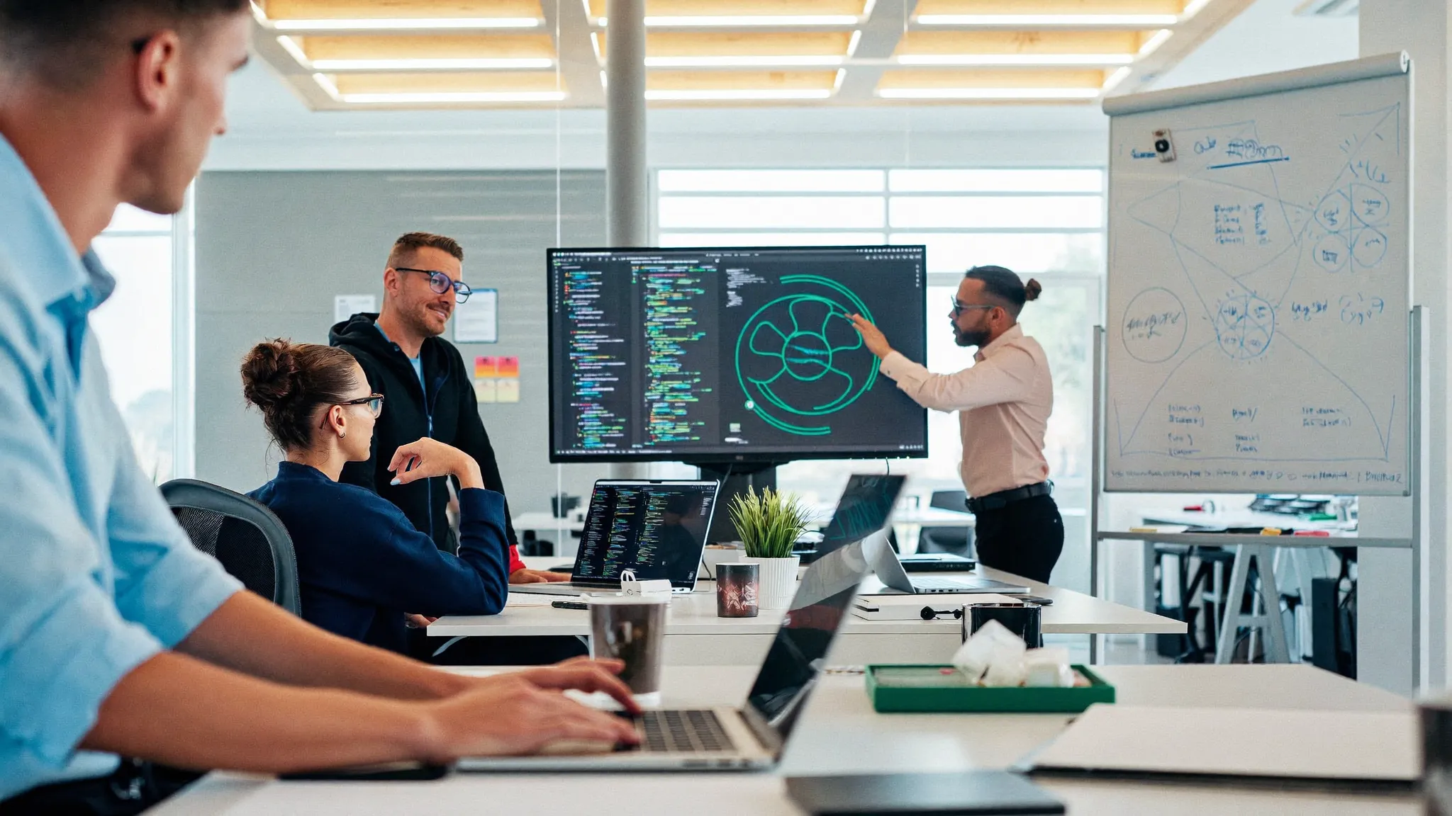 AI engineering team reviewing model architecture on a monitor