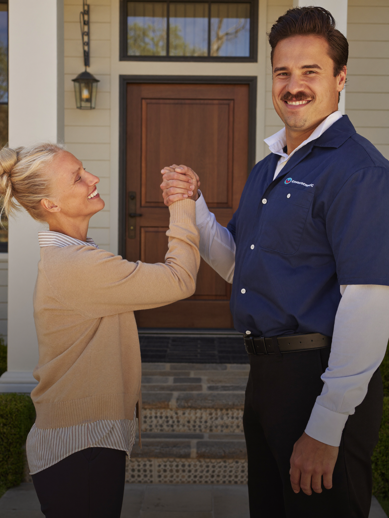HVAC technician with a happy homeowner