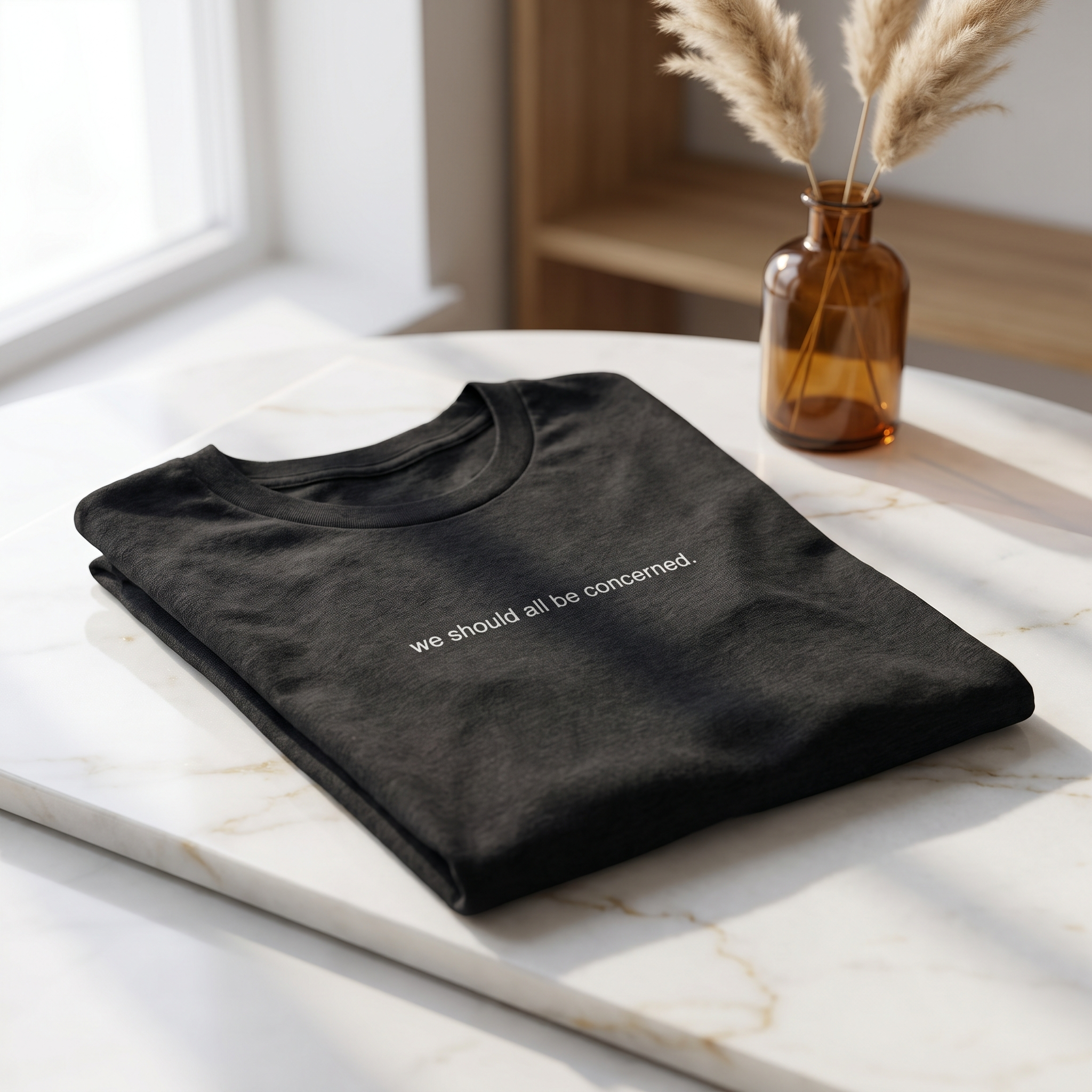 we should all be concerned. — GiveBert tee, folded on a marble counter