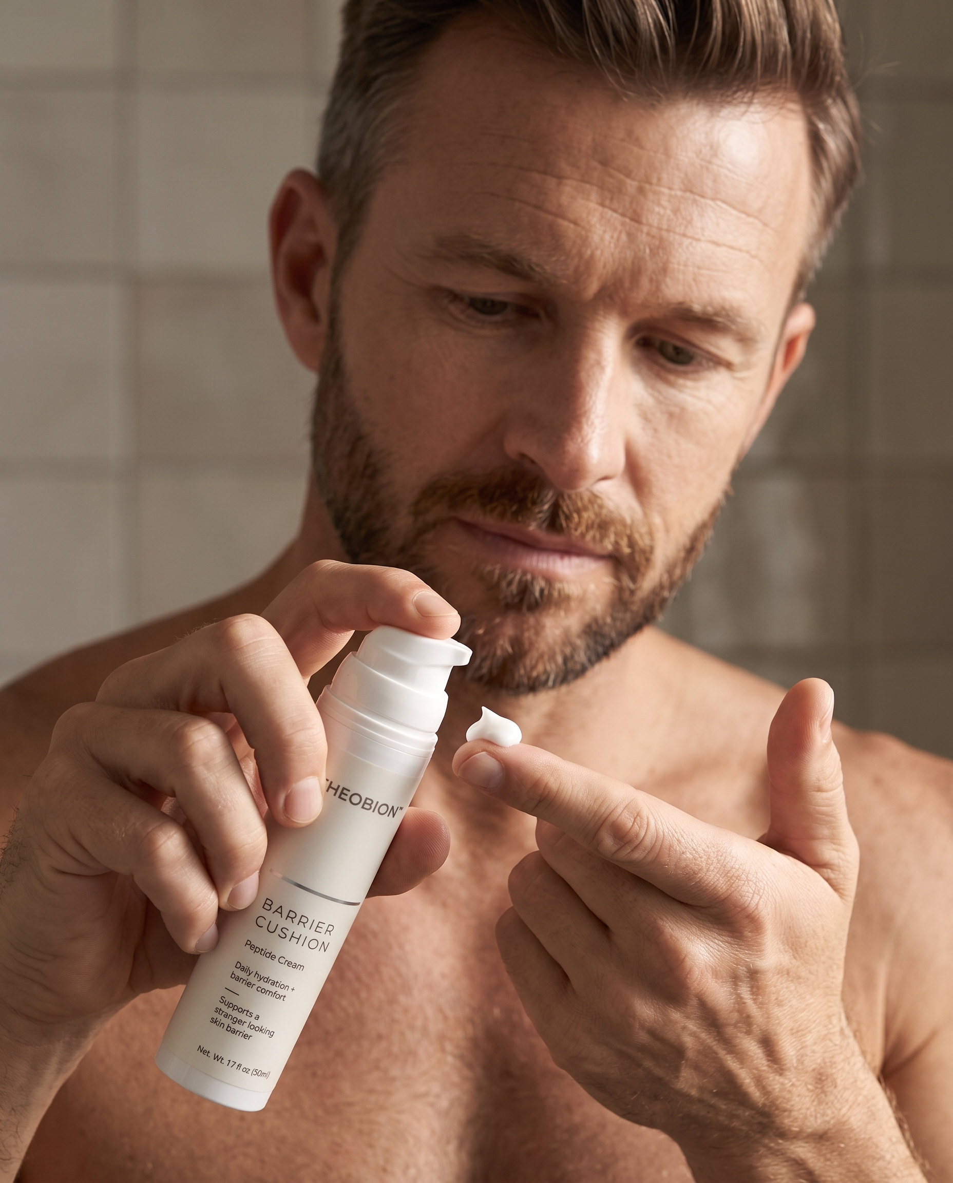 Man dispensing a dime-sized amount of cream onto his fingertip