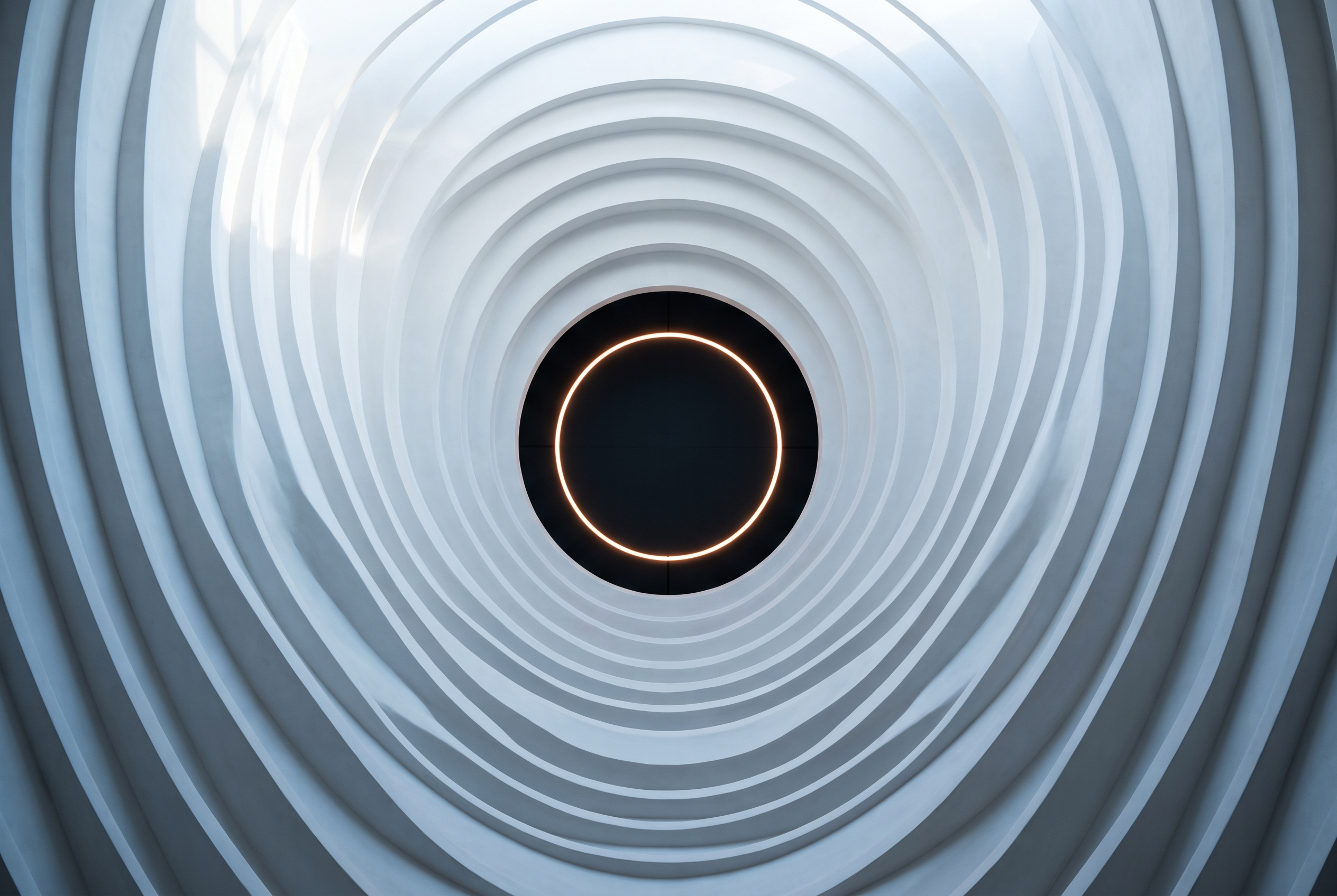 A curved acoustic chamber of white plaster fins radiating toward a single lit aperture
