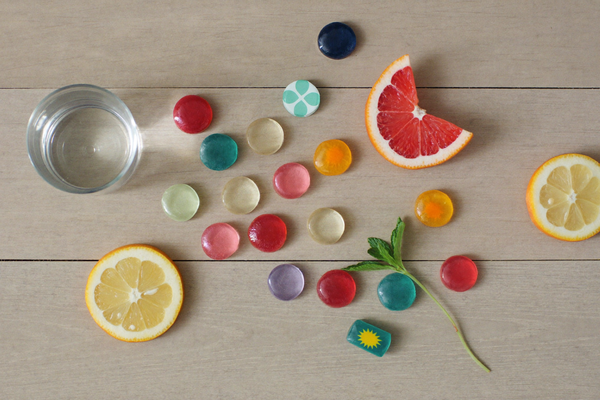 Gummies and a glass of water on a kitchen counter