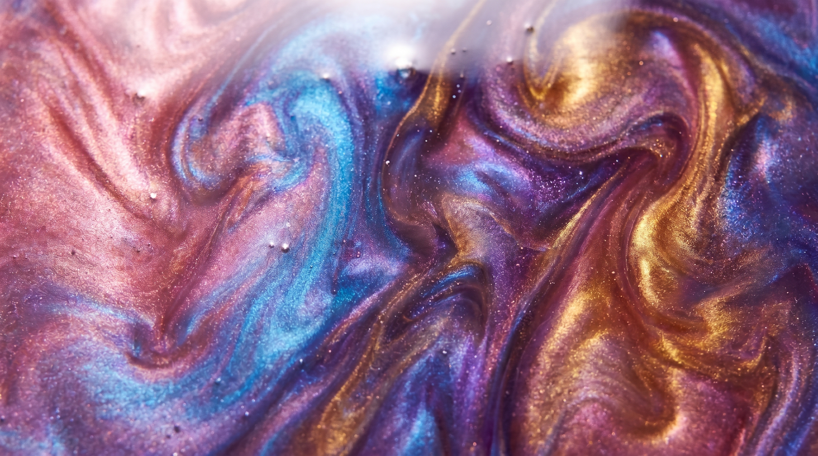 Iridescent epoxy resin art with swirling pearl pigment shimmer in pink, blue, violet and gold