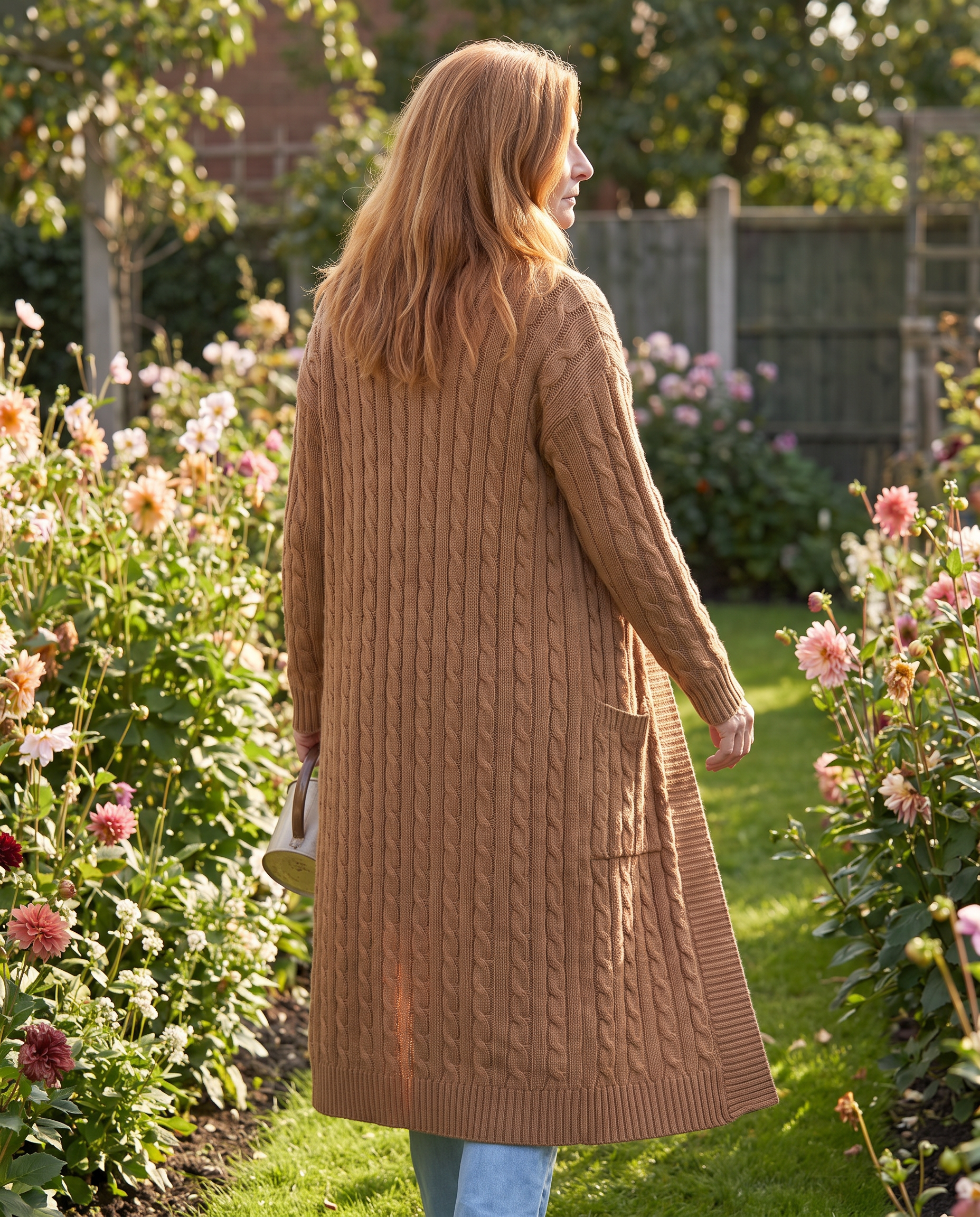 Harriet Longline Cable Knit Cardigan worn on a garden path