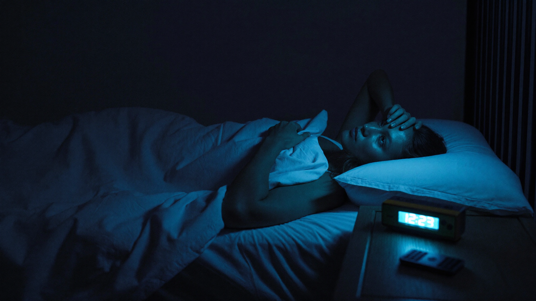 Woman lying awake at 3 AM staring at the ceiling