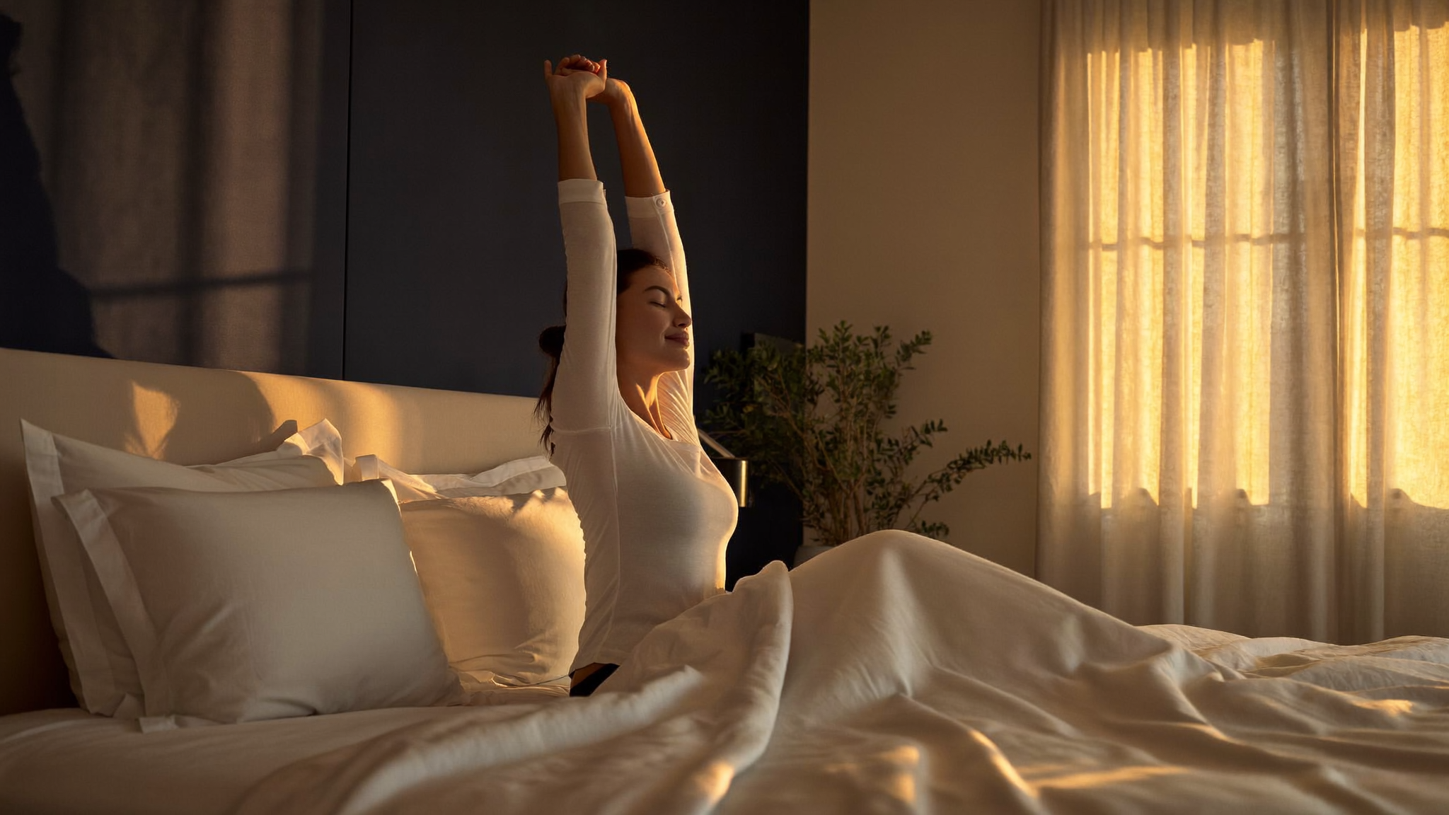 Woman waking up refreshed in warm morning light