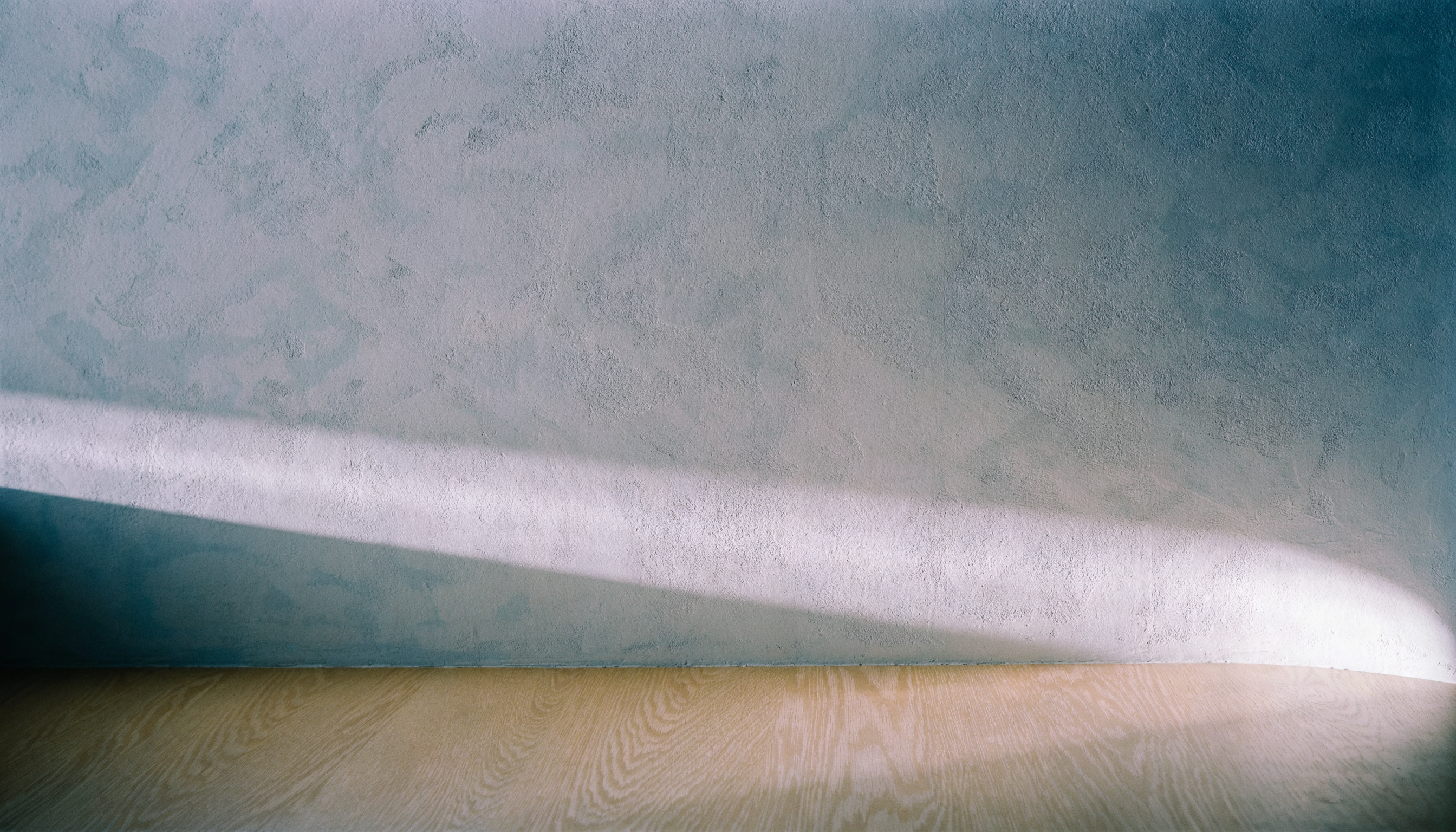 Soft north light on a pale wall — abstract architectural photography