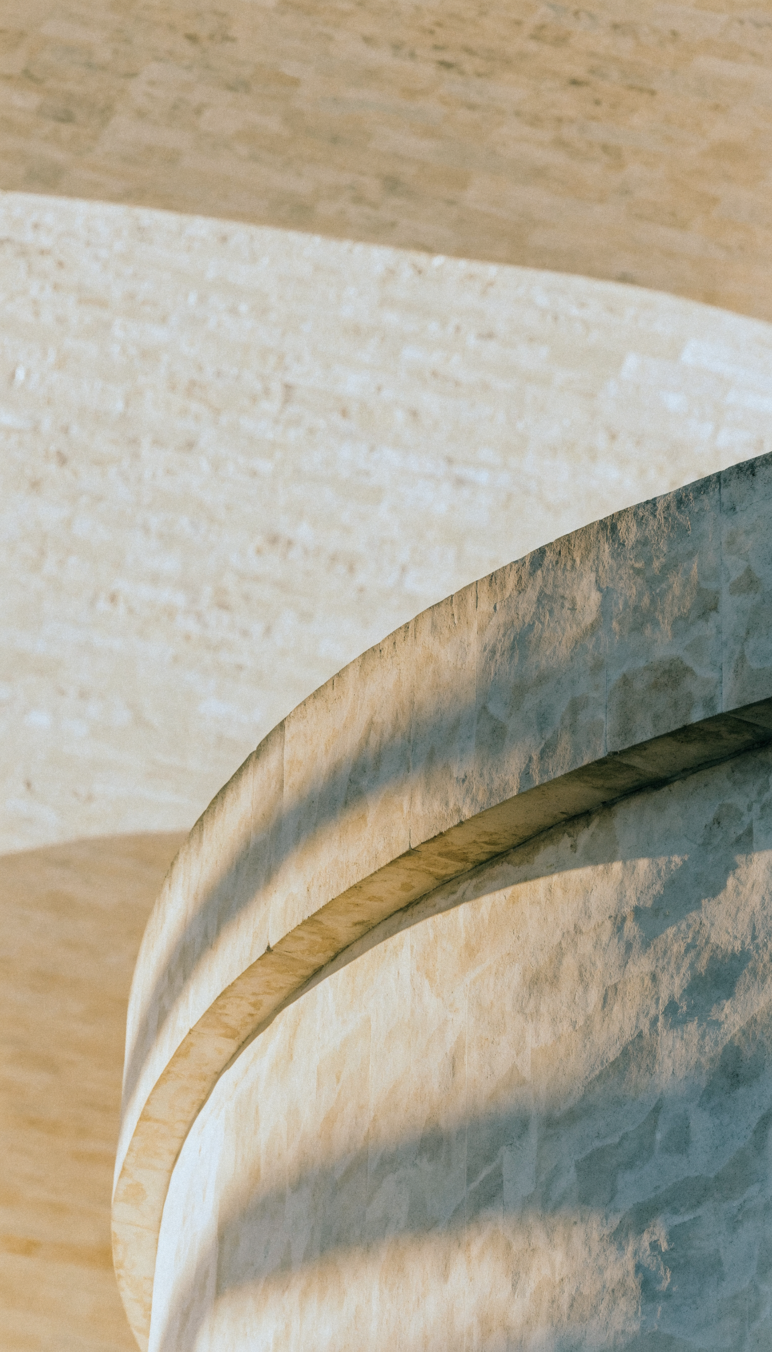Late afternoon light across a limestone wall — abstract architectural photography