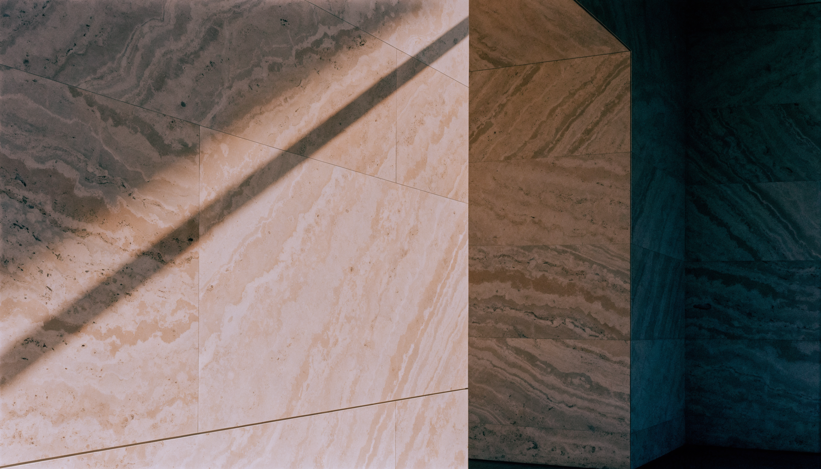 Late afternoon light across a limestone wall — abstract architectural photography
