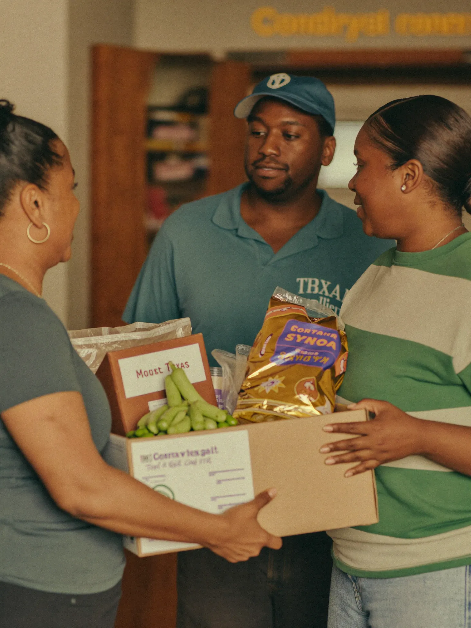 Volunteers handing essentials to a family