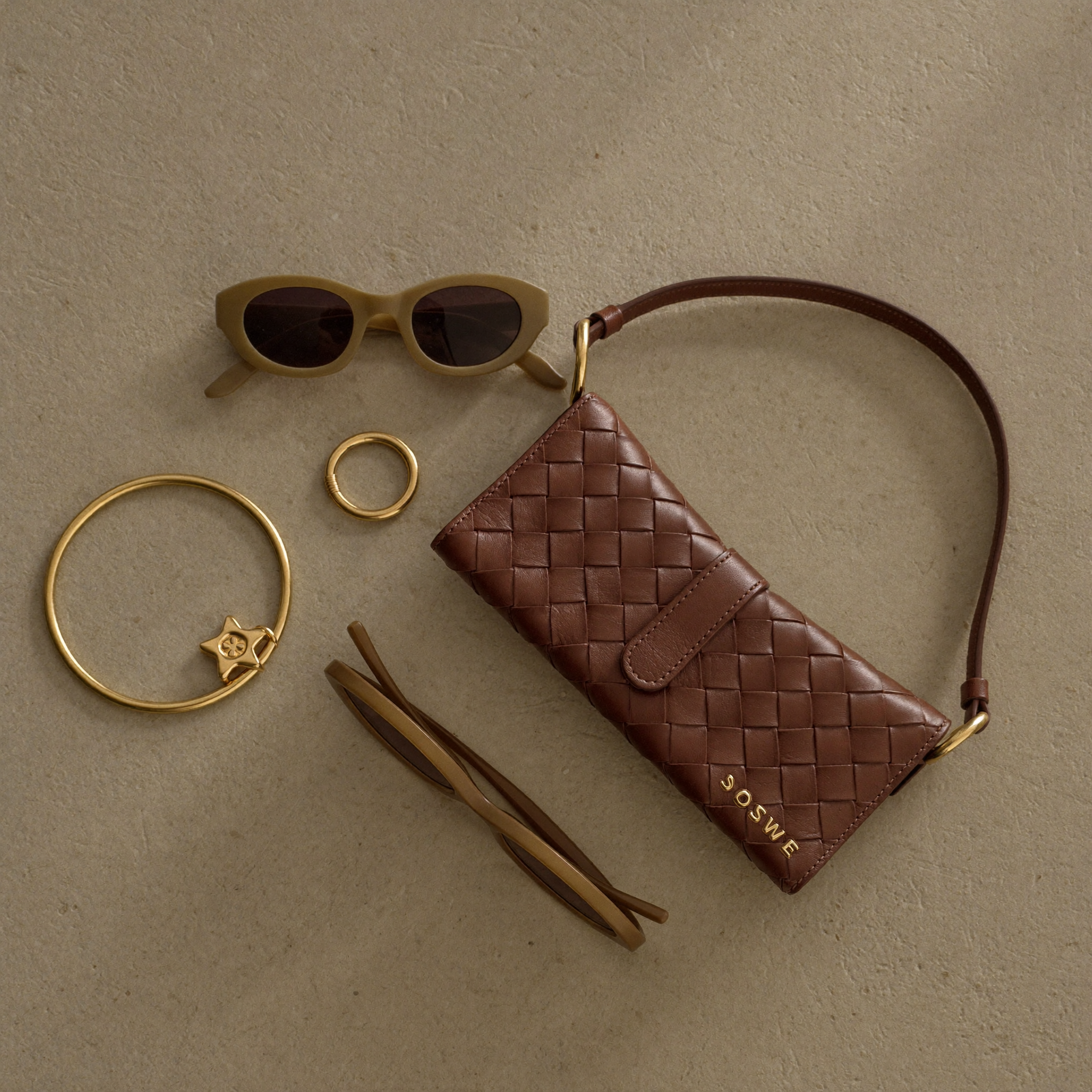 Curated fashion accessories still life in earth tones
