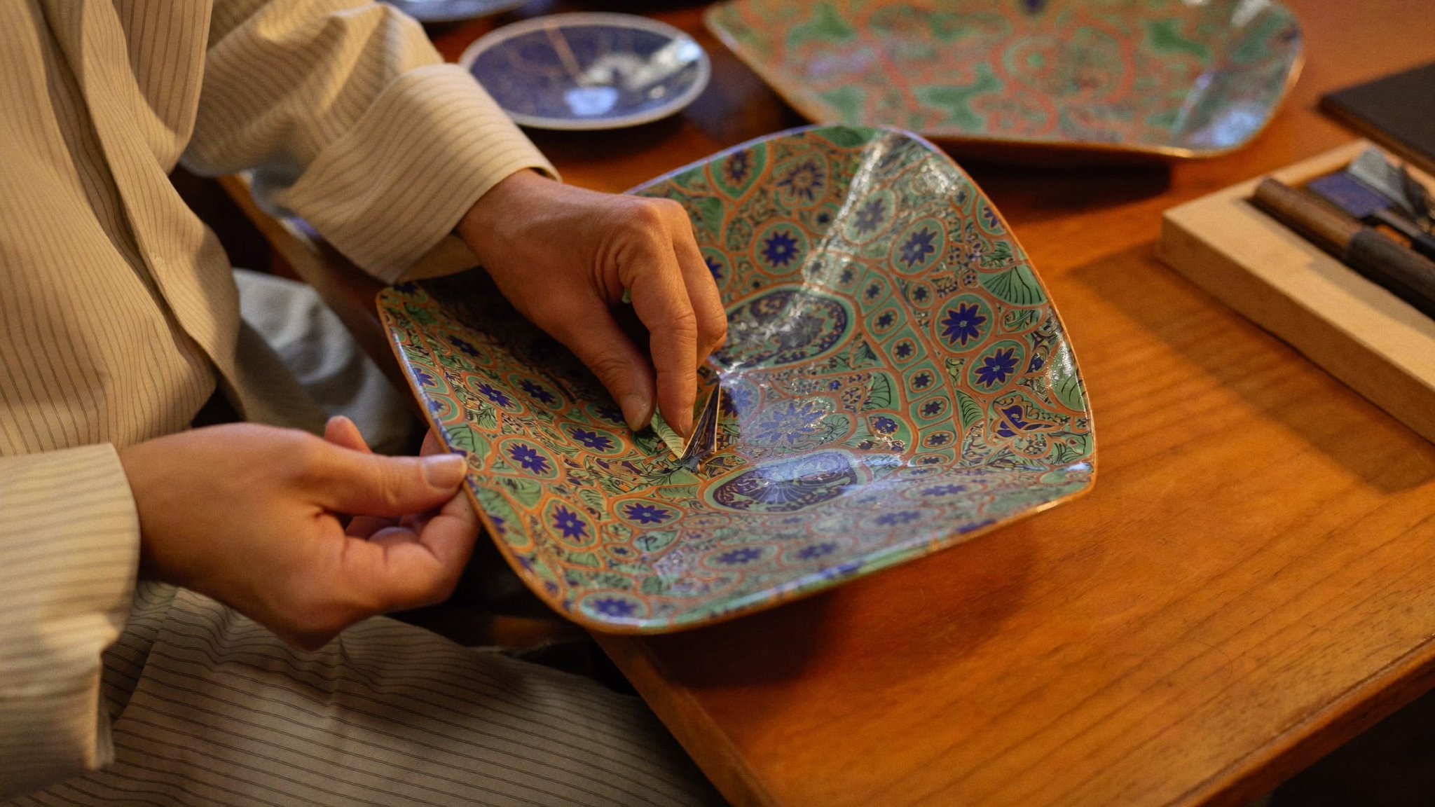 Korean traditional craft artisan hands working on lacquerware inlay inspired by a video game collaboration