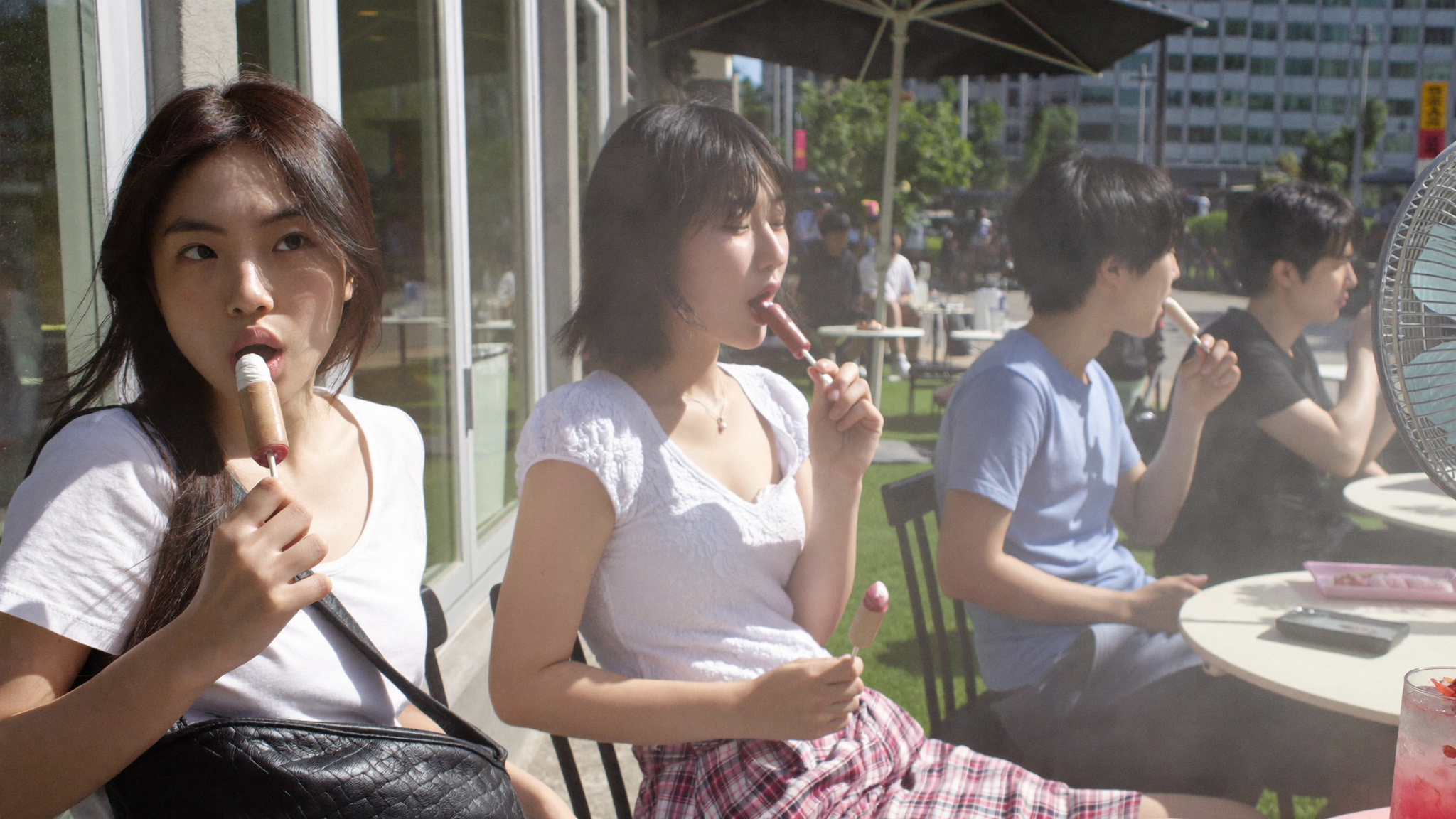 Young Koreans eating shaved ice bingsu to cool down during Korea's highest-ever heat warning